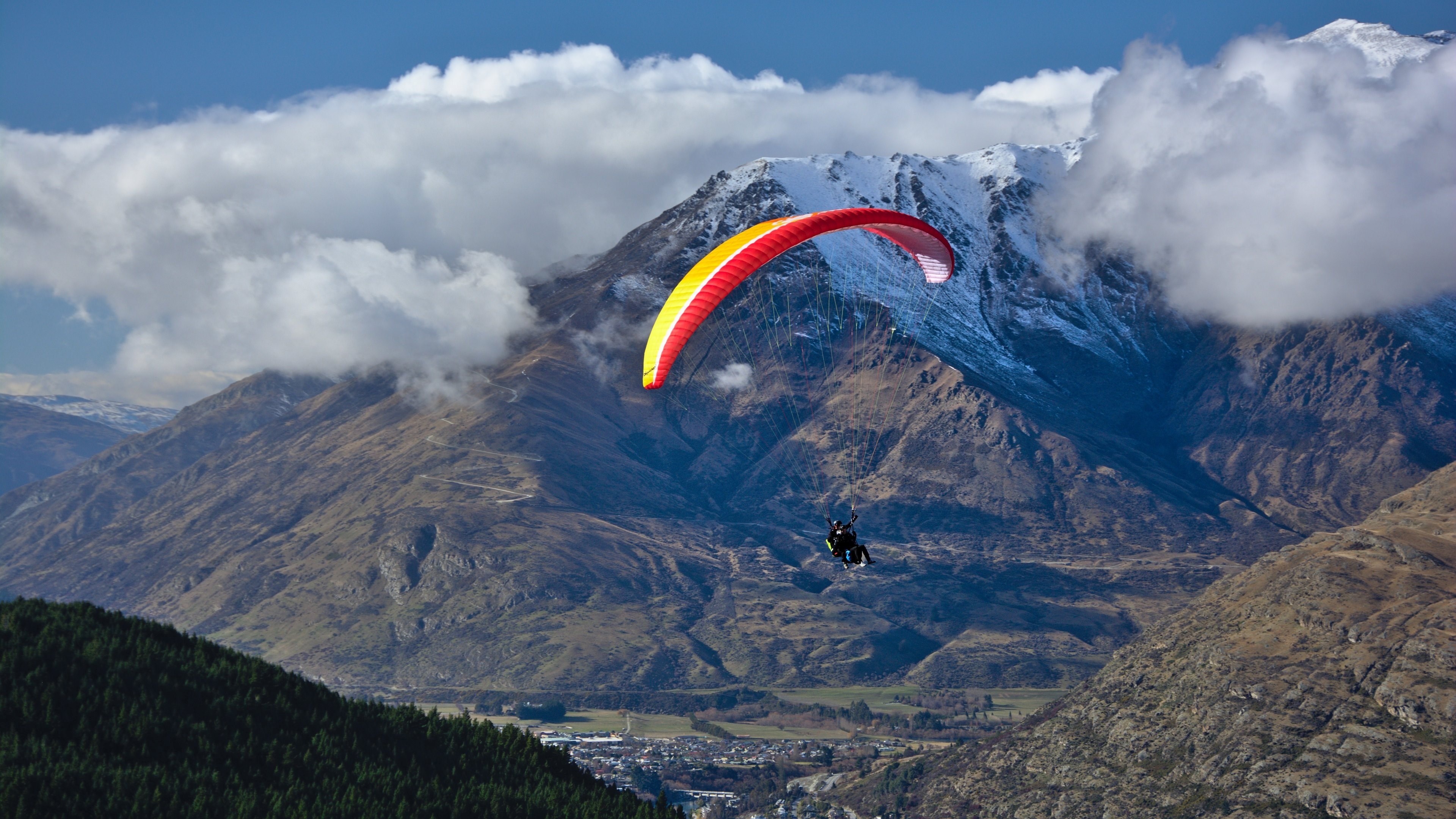 Paragliding: Ram-air airfoil, Parachute as a wing, Gliding in the mountains. 3840x2160 4K Background.