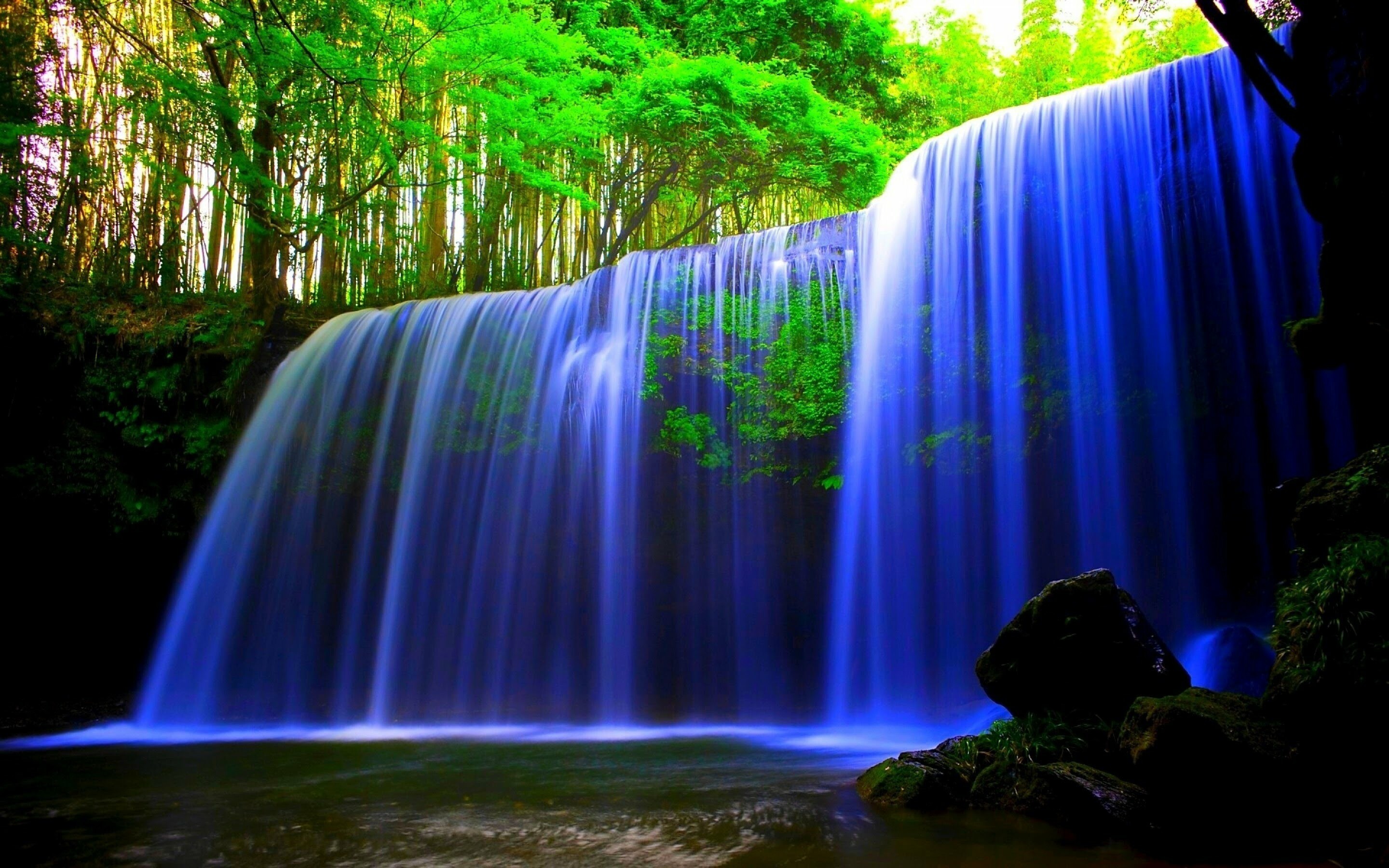 Waterfall: Water that drops in a constricted form and then spreads out in a wider pool. 2880x1800 HD Background.