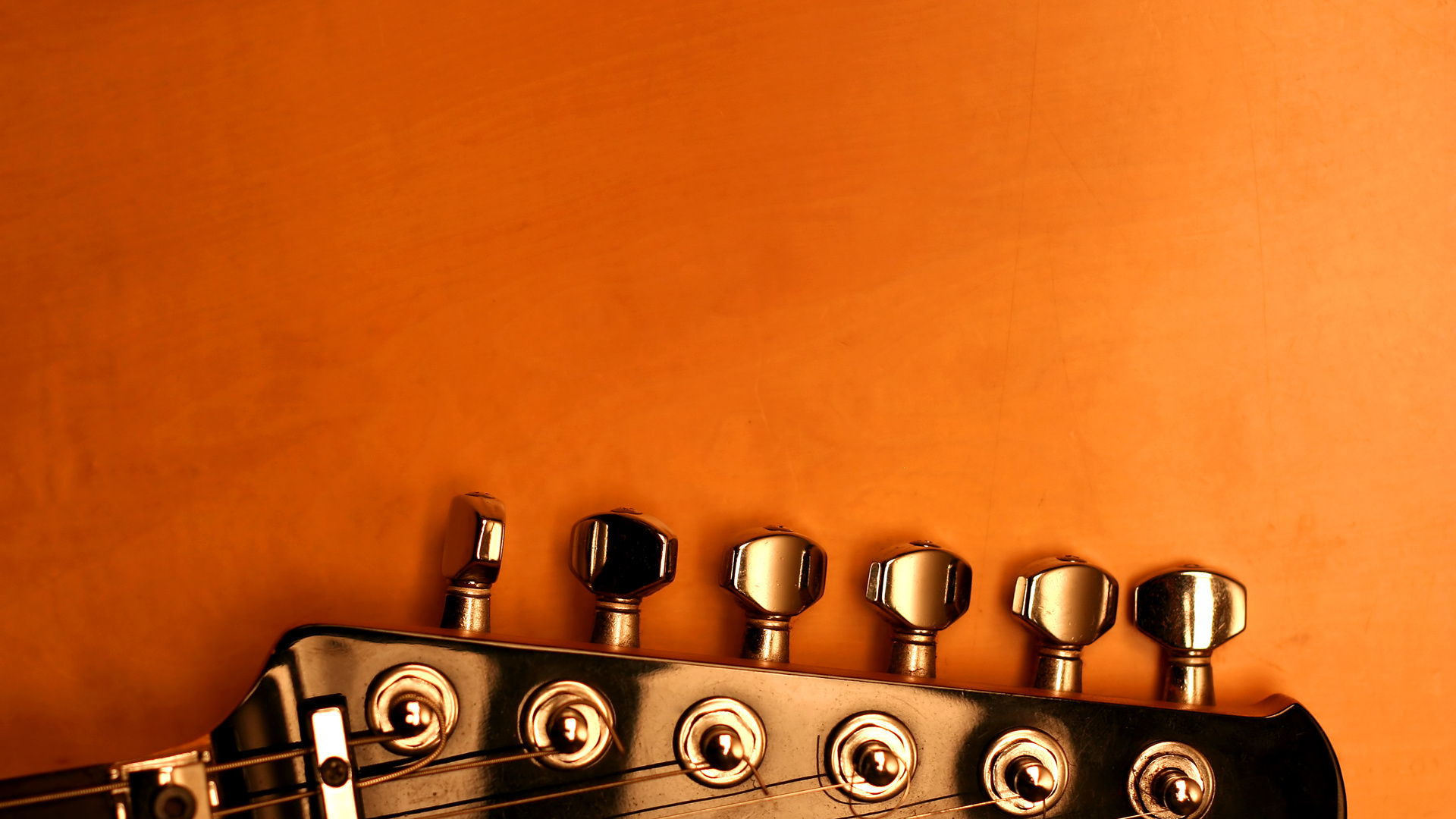 Guitar: A musical instrument projecting sound either acoustically or amplified by an electronic pickup and an amplifier. 1920x1080 Full HD Background.