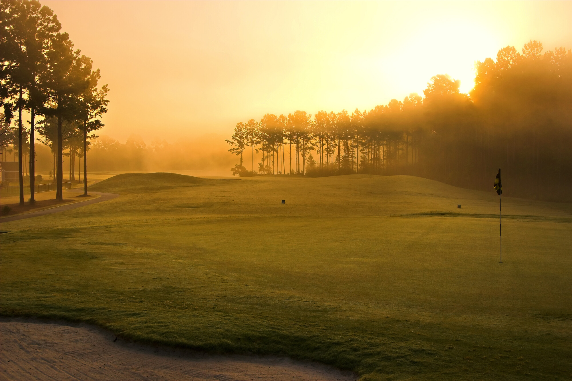 Golf: A grass course that includes a tee box, fairway, and green, Sand bunker. 2000x1340 HD Background.