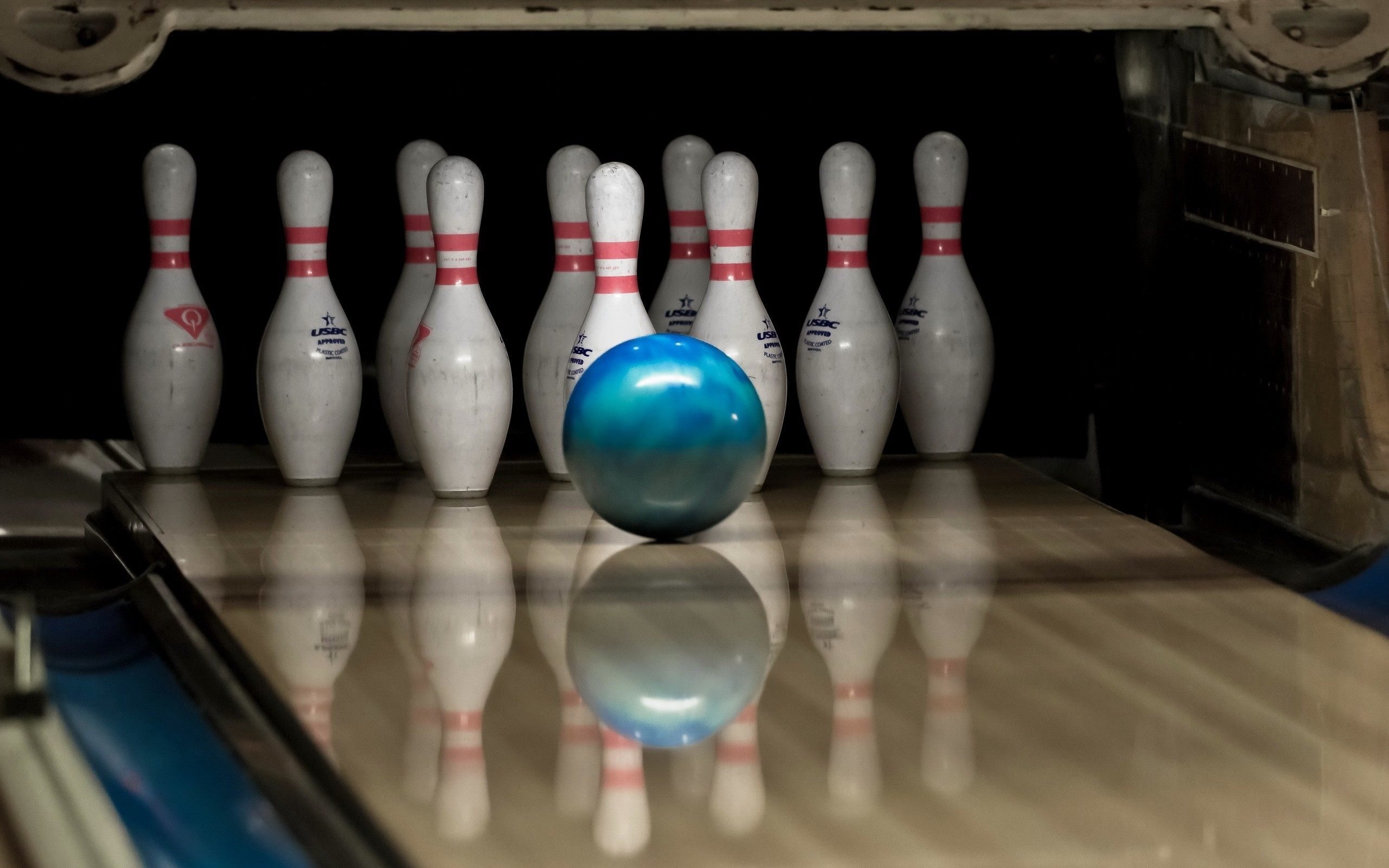 Bowling: The pastime in which players roll heavy balls along a special track towards a group of pins. 2560x1600 HD Background.