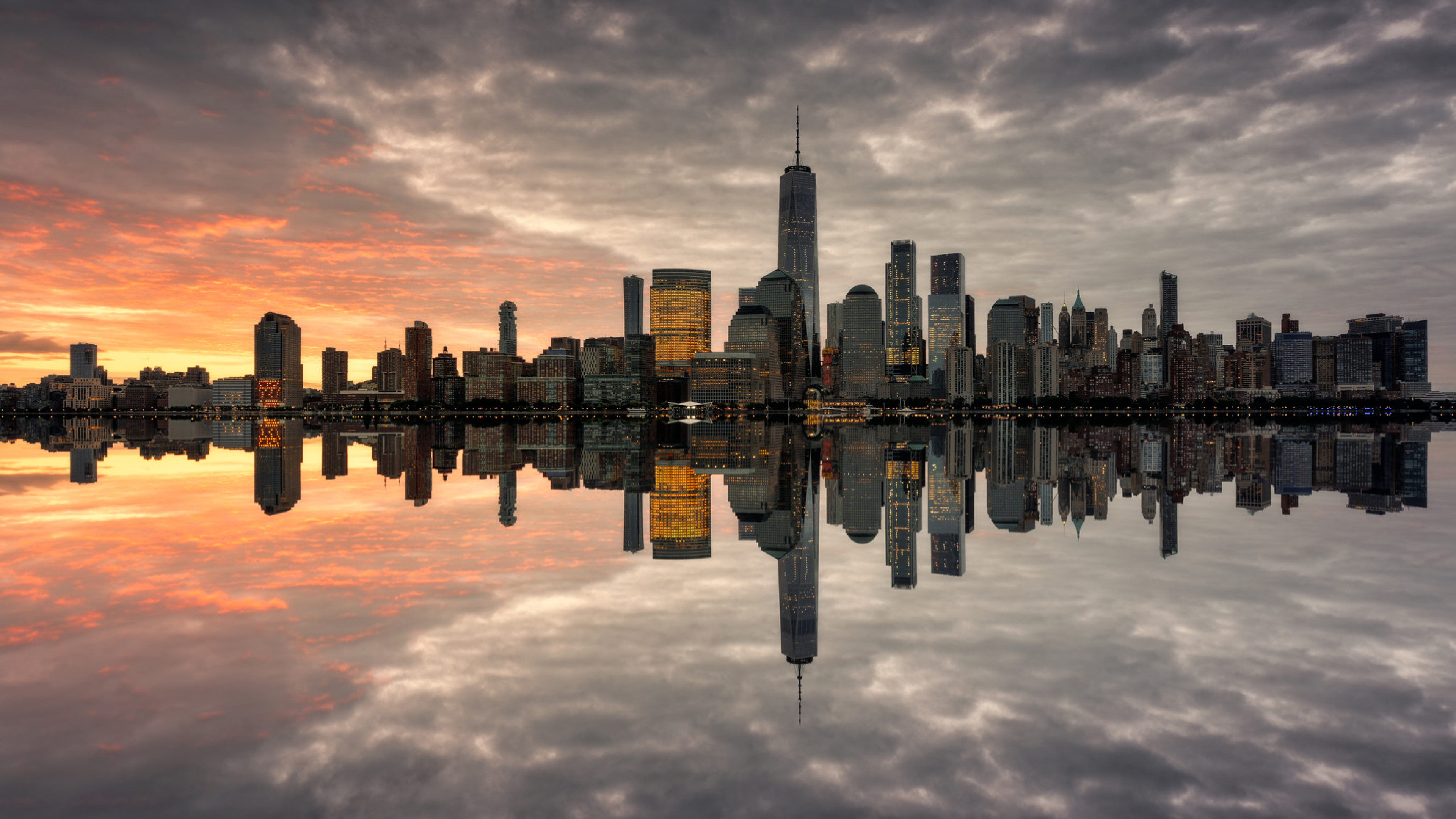 New York: Manhattan skyline, Sunset, Reflection in the water mirror. 3840x2160 4K Background.