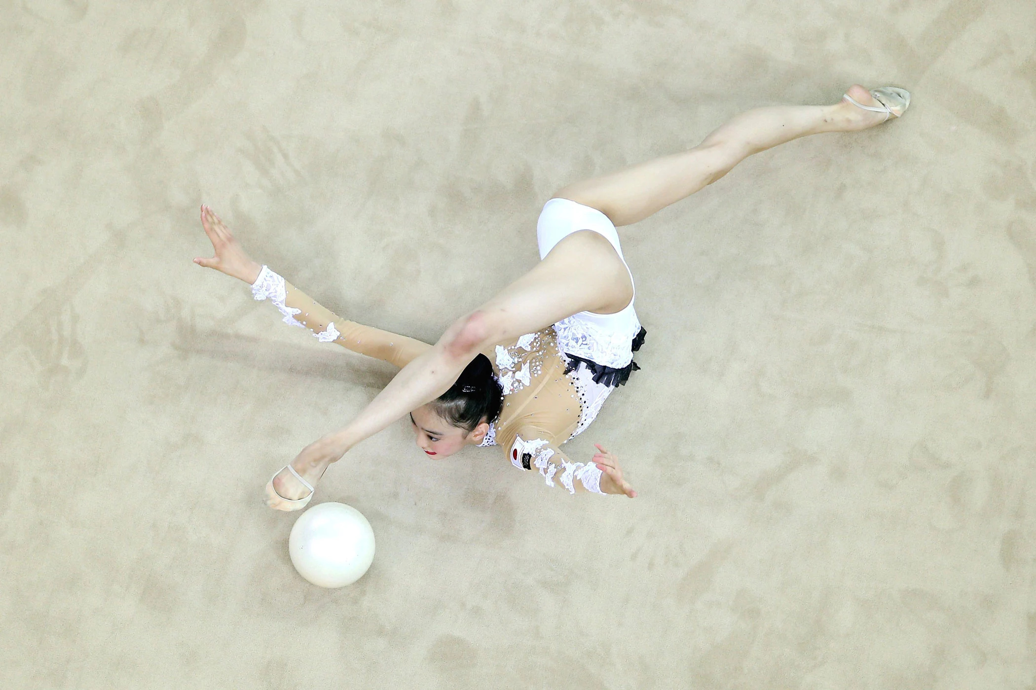 Rhythmic Gymnastics: A professional artistic performance by a gymnast equipped with a ball. 2100x1400 HD Background.