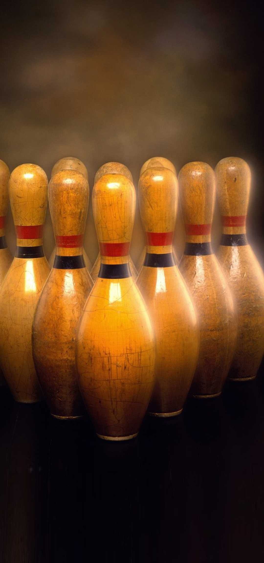 Bowling: An activity which goal is to knock down the pins set at the end of the board-less track. 1080x2300 HD Background.