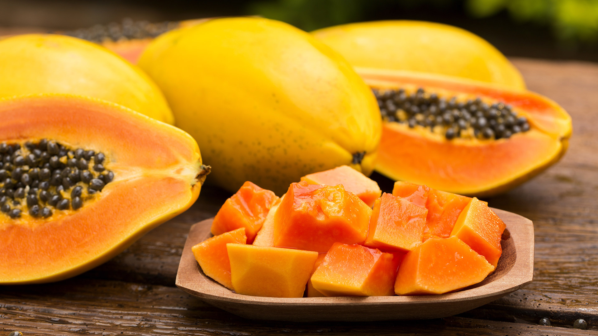Papaya: A large oval fruit with a yellowish skin and sweet orange flesh. 1920x1080 Full HD Background.