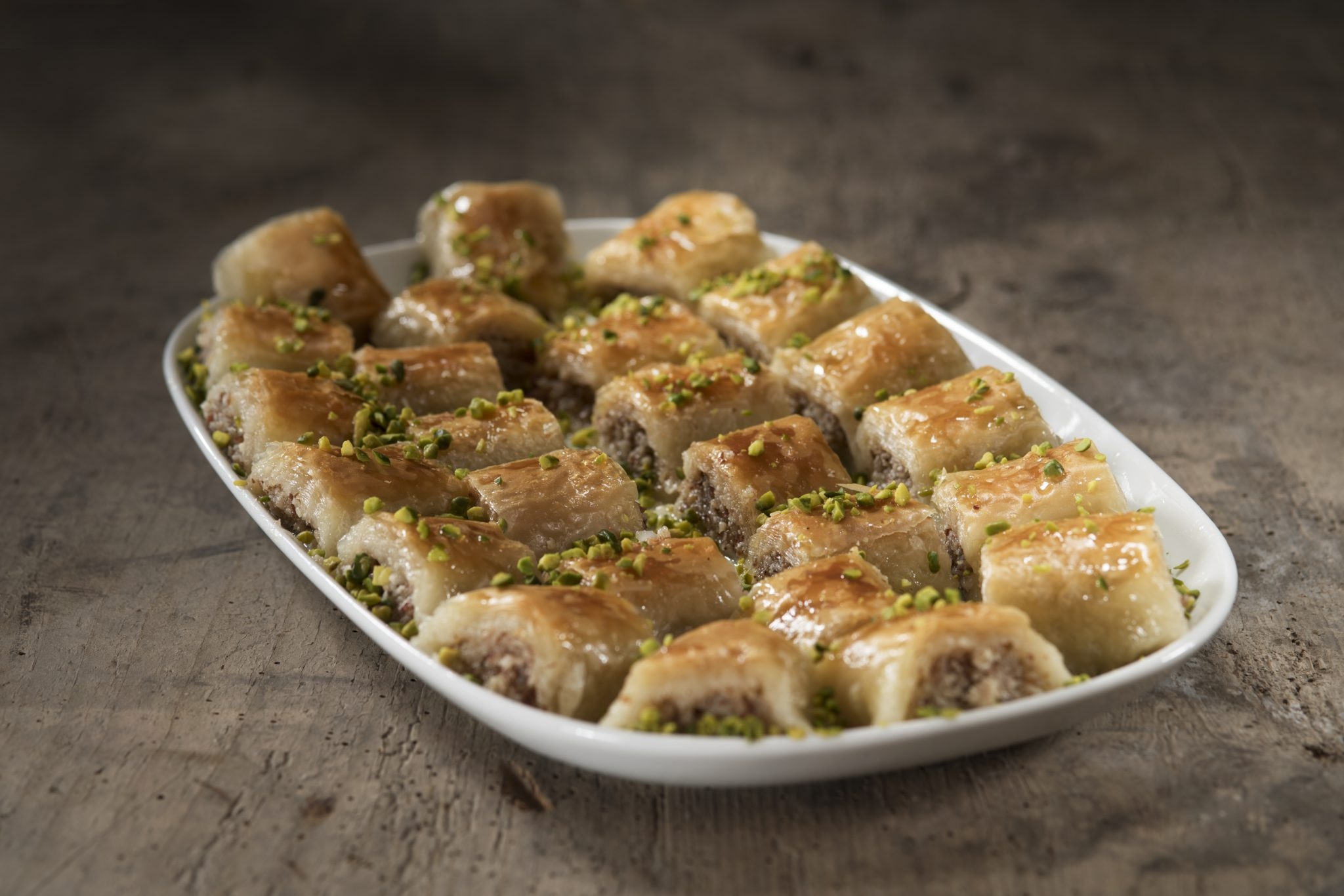 Baklava: A sweet syrup is poured over the baked dessert, Baked goods. 2050x1370 HD Background.
