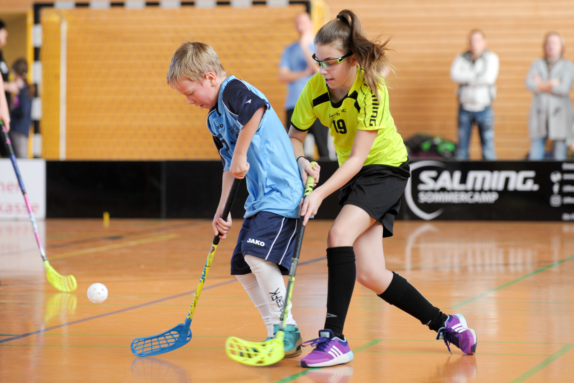 Floorball: A recreational and competitive sports discipline for both girls and men. 1920x1280 HD Background.