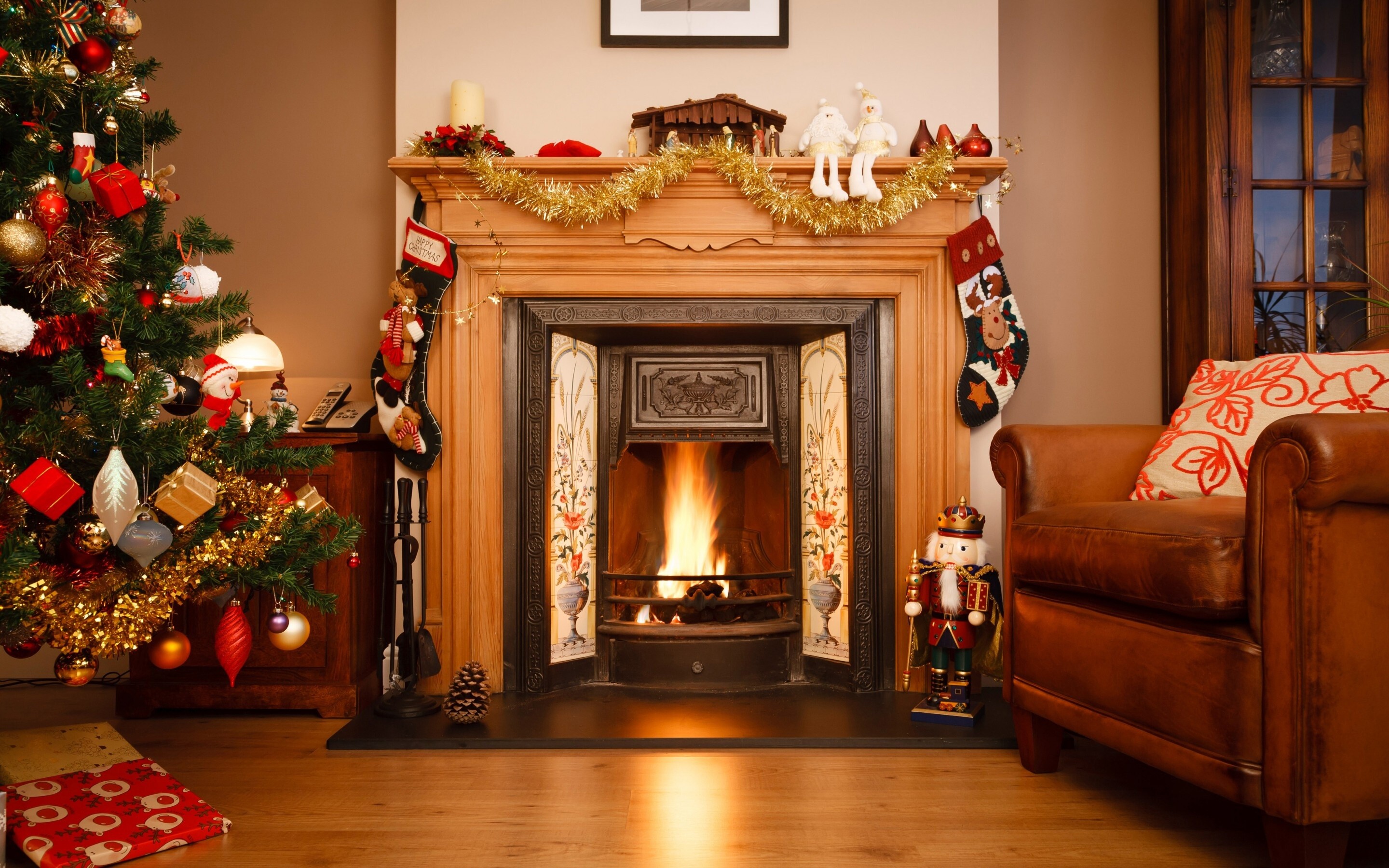 Christmas Fireplace: Fire, Chair, Toys, Gift, Decoration. 2880x1800 HD Background.