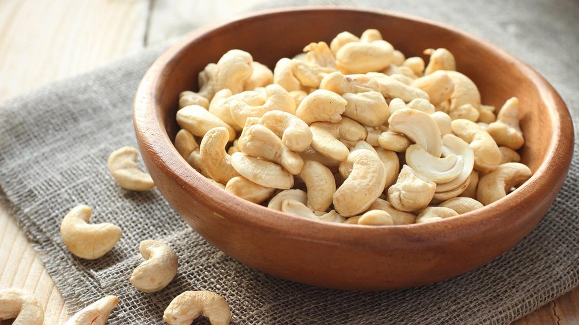 Cashew Nuts: Curved edible seeds, Rich in oil and distinctively flavored. 1920x1080 Full HD Background.