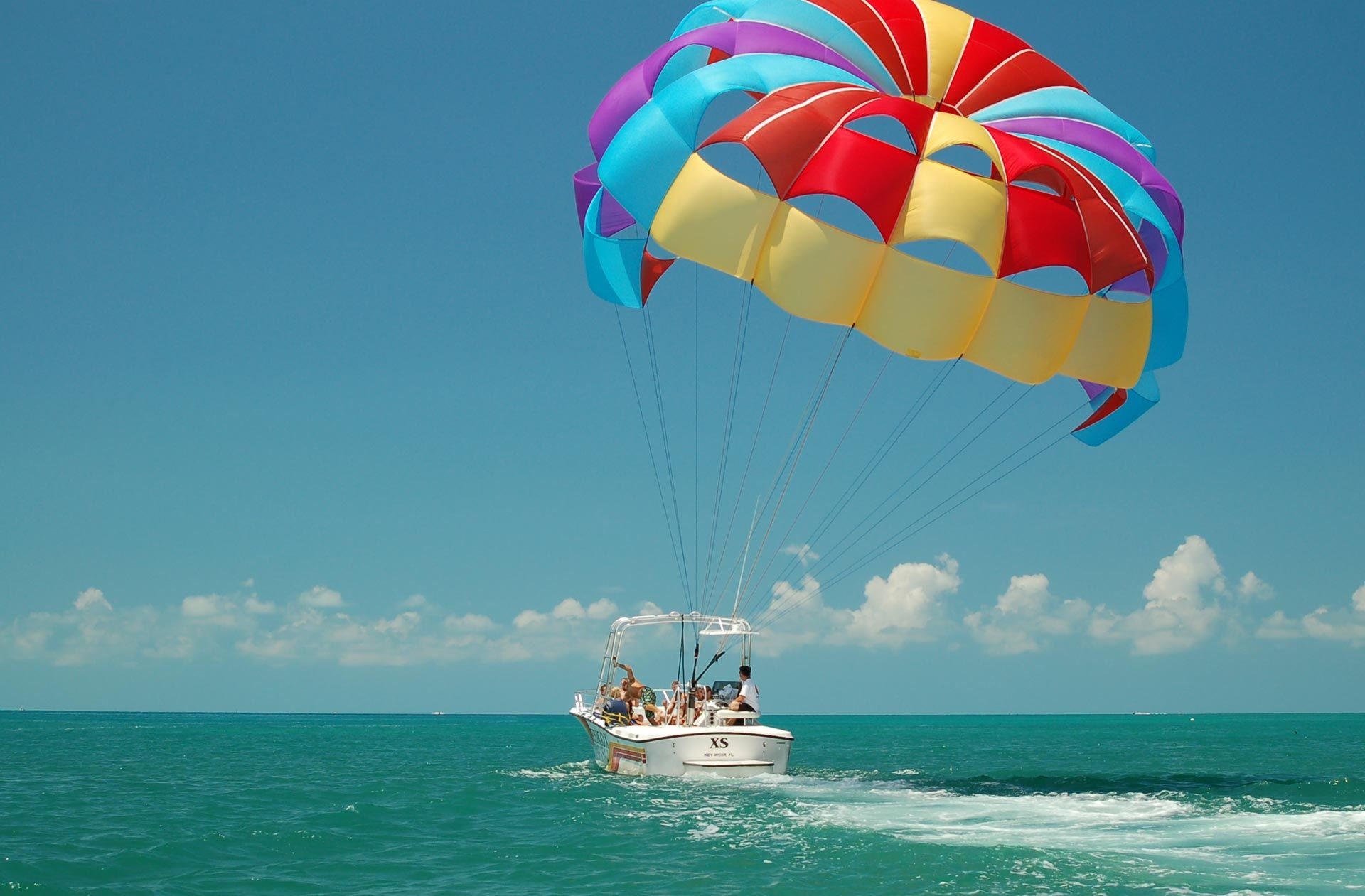 Parasailing: People sailing in the air, A recreational kiting activity, Towed behind a boat, Parachute, Key West. 1920x1270 HD Wallpaper.