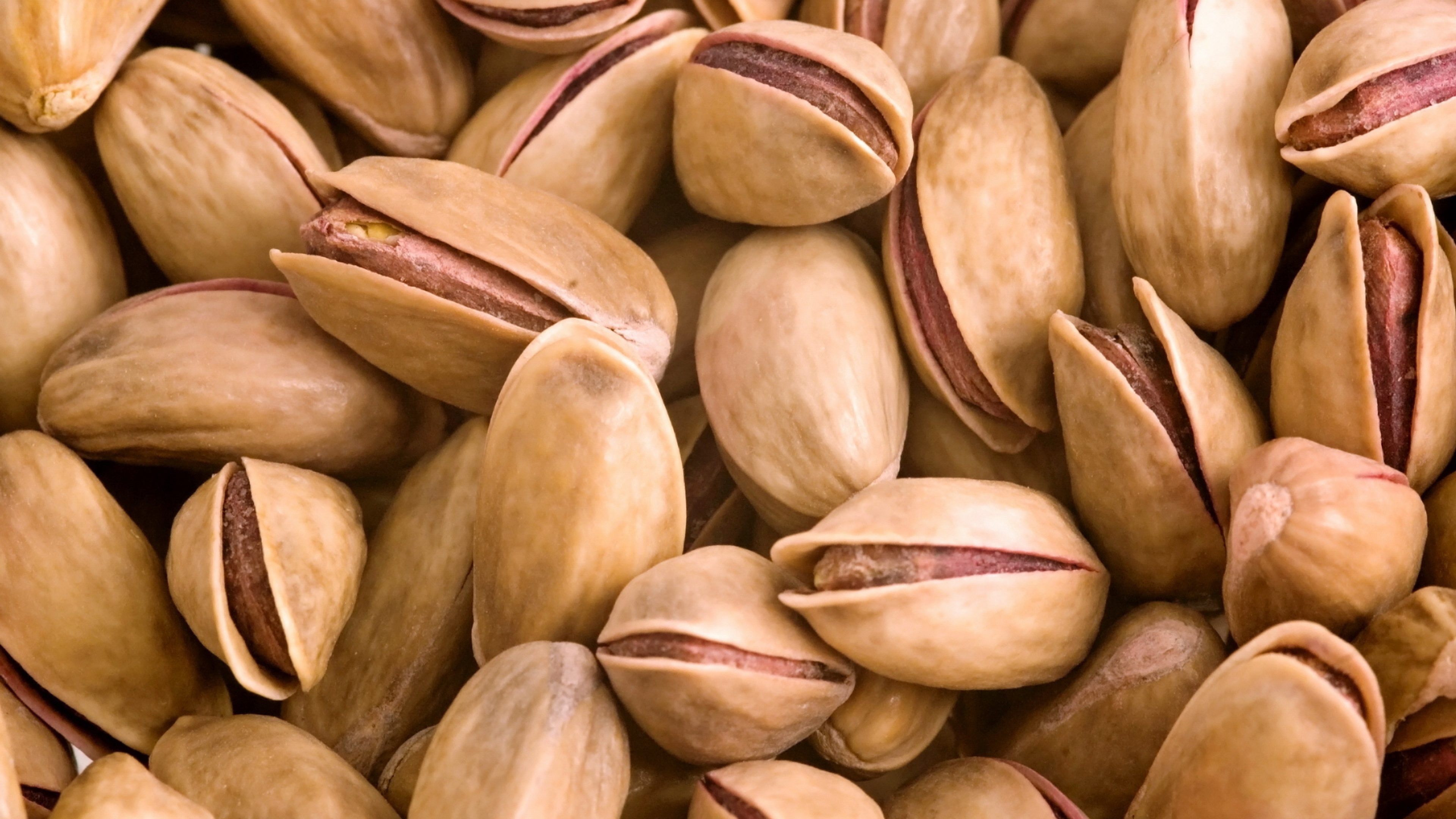 Nuts: Pistachio, A drupe, containing an elongated seed, which is the edible portion. 3840x2160 4K Background.