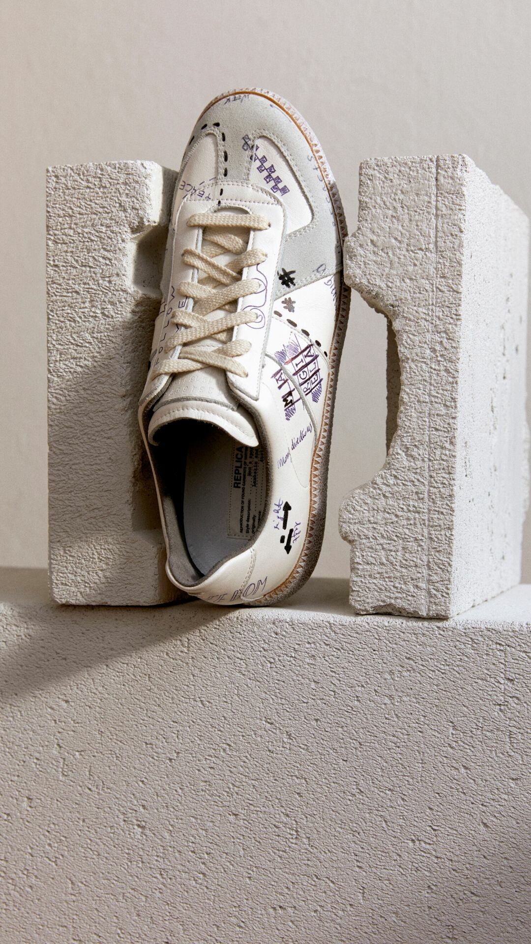 Maison Margiela: The iconoclastic, avant-garde fashion house, founded in Paris in 1988, 'Vintage Replica' trainers. 1080x1920 Full HD Background.