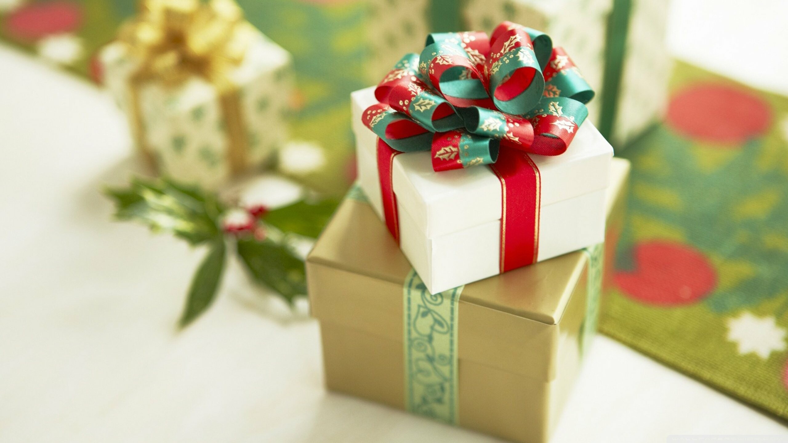 Christmas Gifts: The big or small boxes wrapped brightly with a bow and name tag. 2560x1440 HD Background.