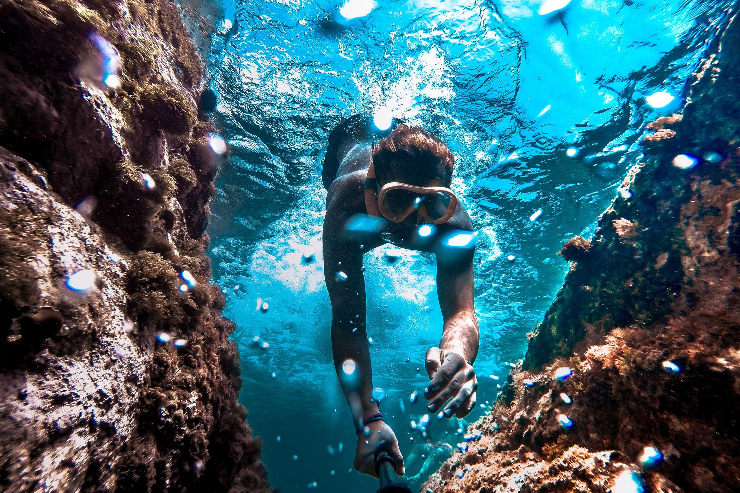 Diving: Freediver explores the reef while filming, Adventurous leisure. 2560x1710 HD Background.