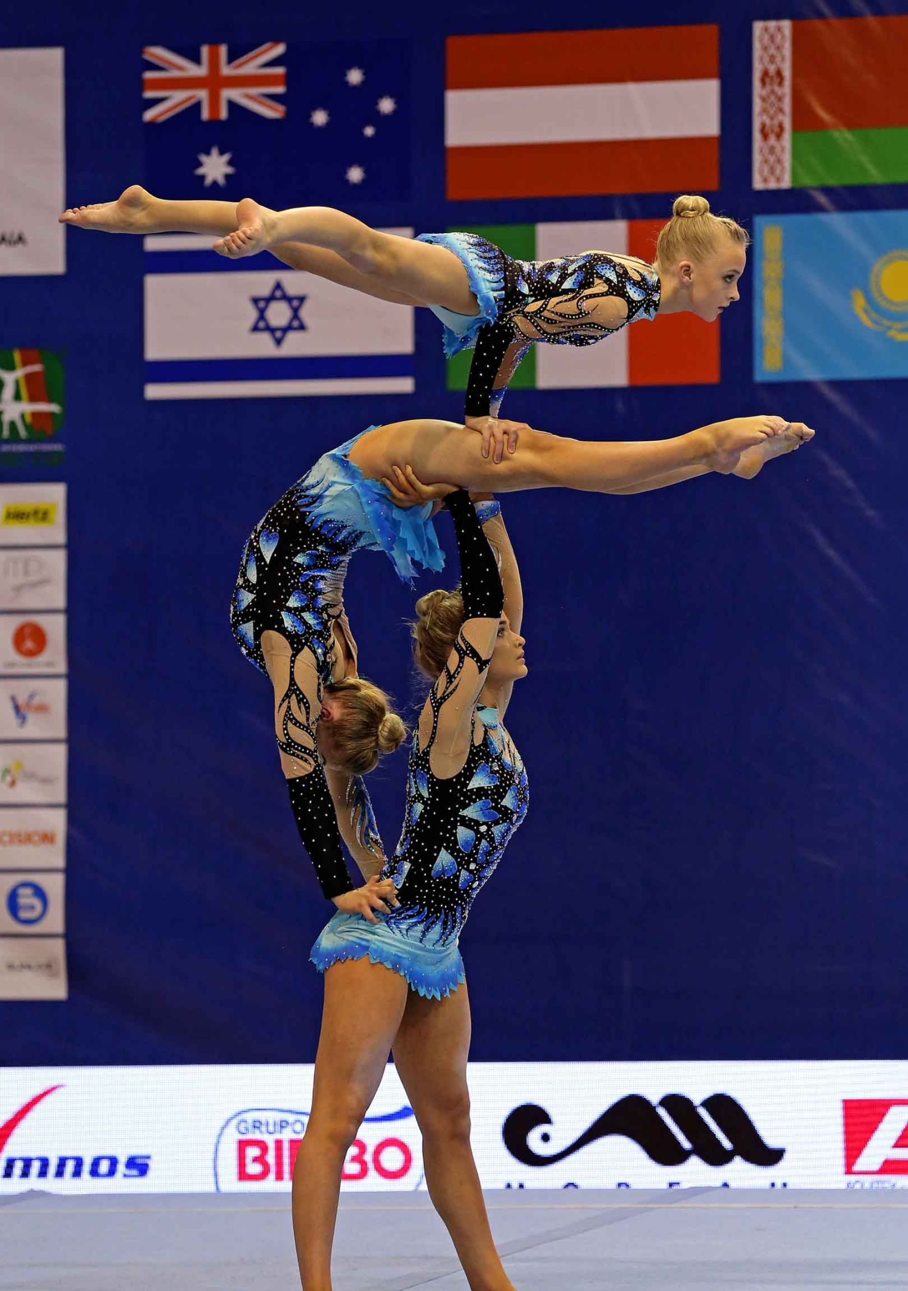 Acrobatic Gymnastics: An artistic performance at the women's team floor event, A competitive sport. 1800x2560 HD Background.