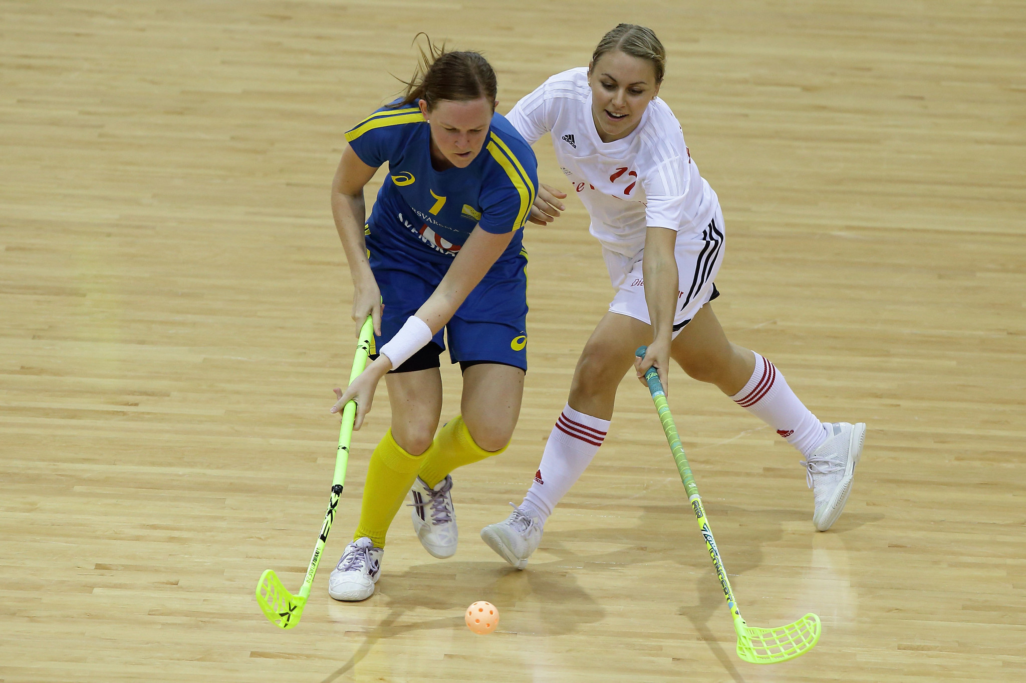 Floorball: Andersson Erika of Sweden and Rahel Kaltenrieder of Switzerland challenge for the ball during the World University Championship. 2050x1370 HD Background.