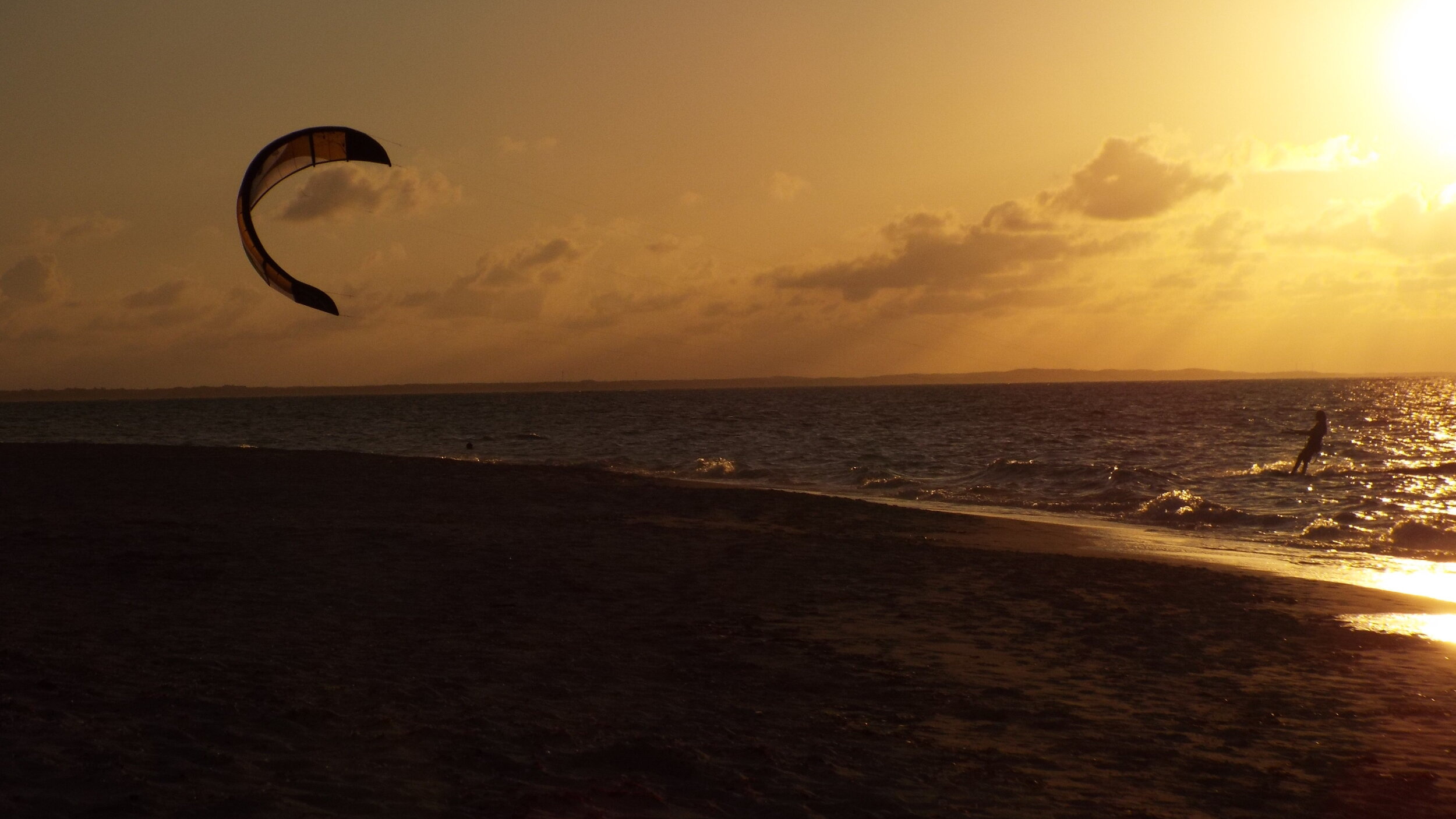 Kiteboarding: Kitesurfing at sunset, A wind-dependent sport, Kite open sea passages. 2500x1410 HD Wallpaper.