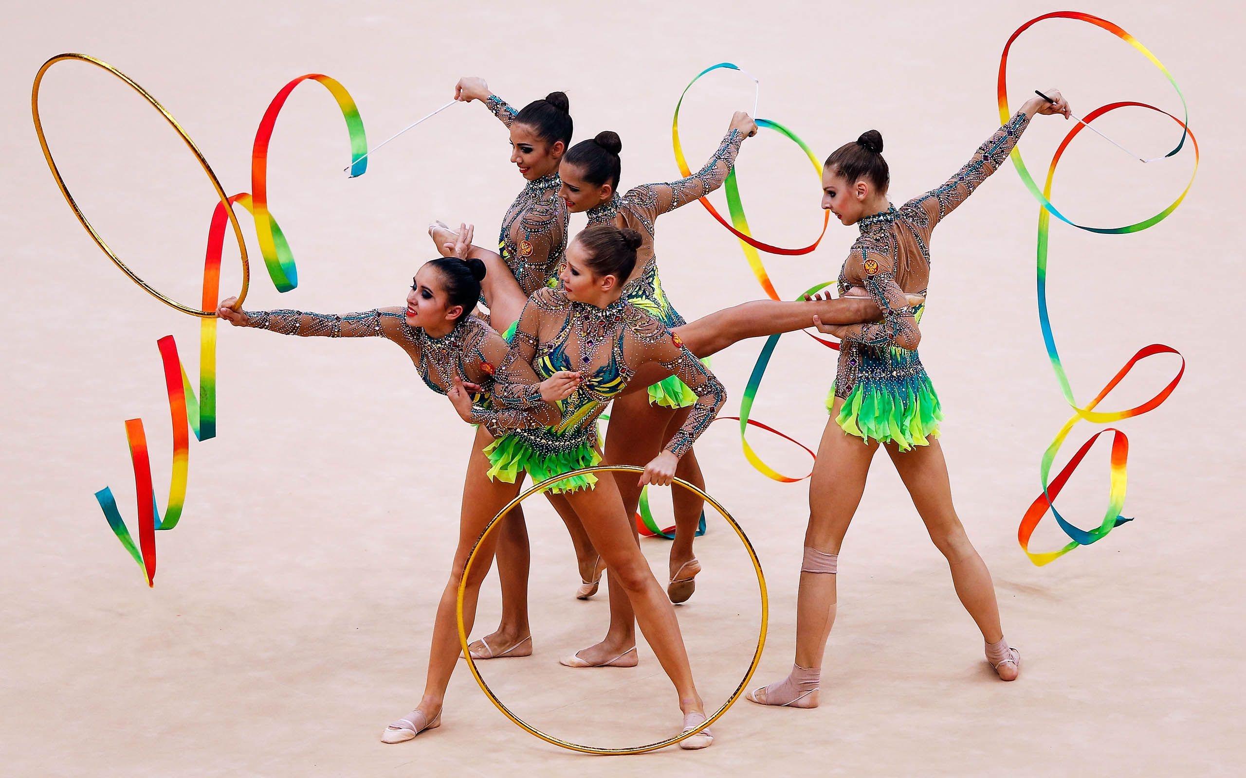 Rhythmic Gymnastics: A group performance with ribbons at the 2012 Summer Olympic Games. 2560x1600 HD Background.