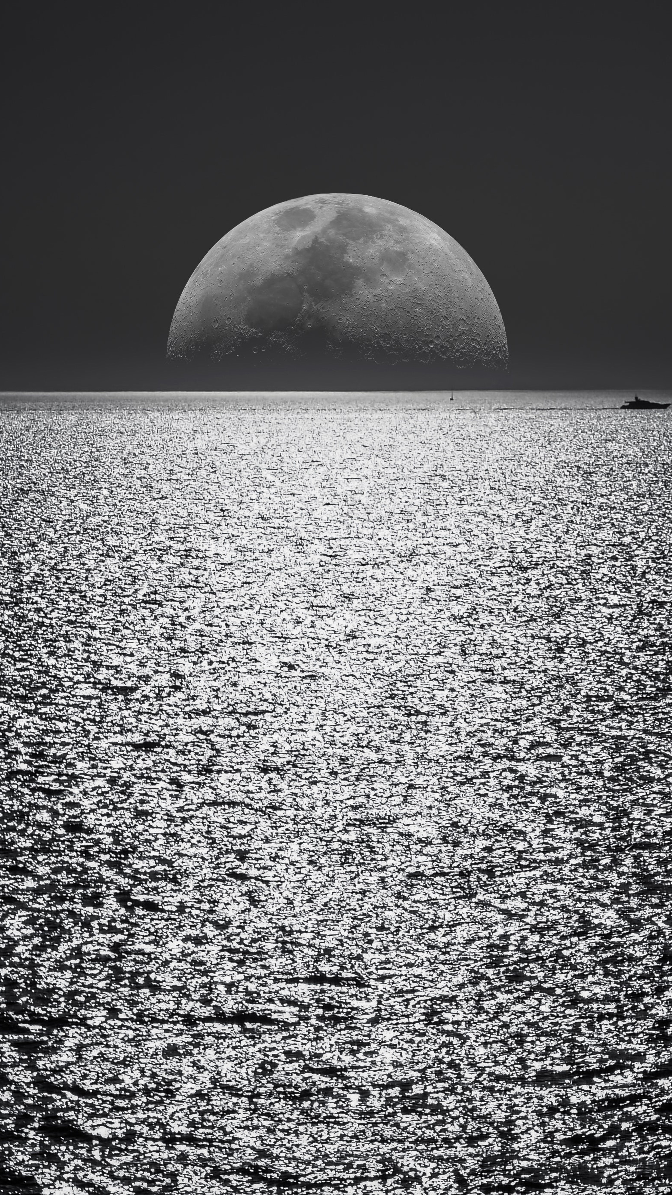 Seascape: Monochrome supermoon view from the board of the ship. 2160x3840 4K Background.