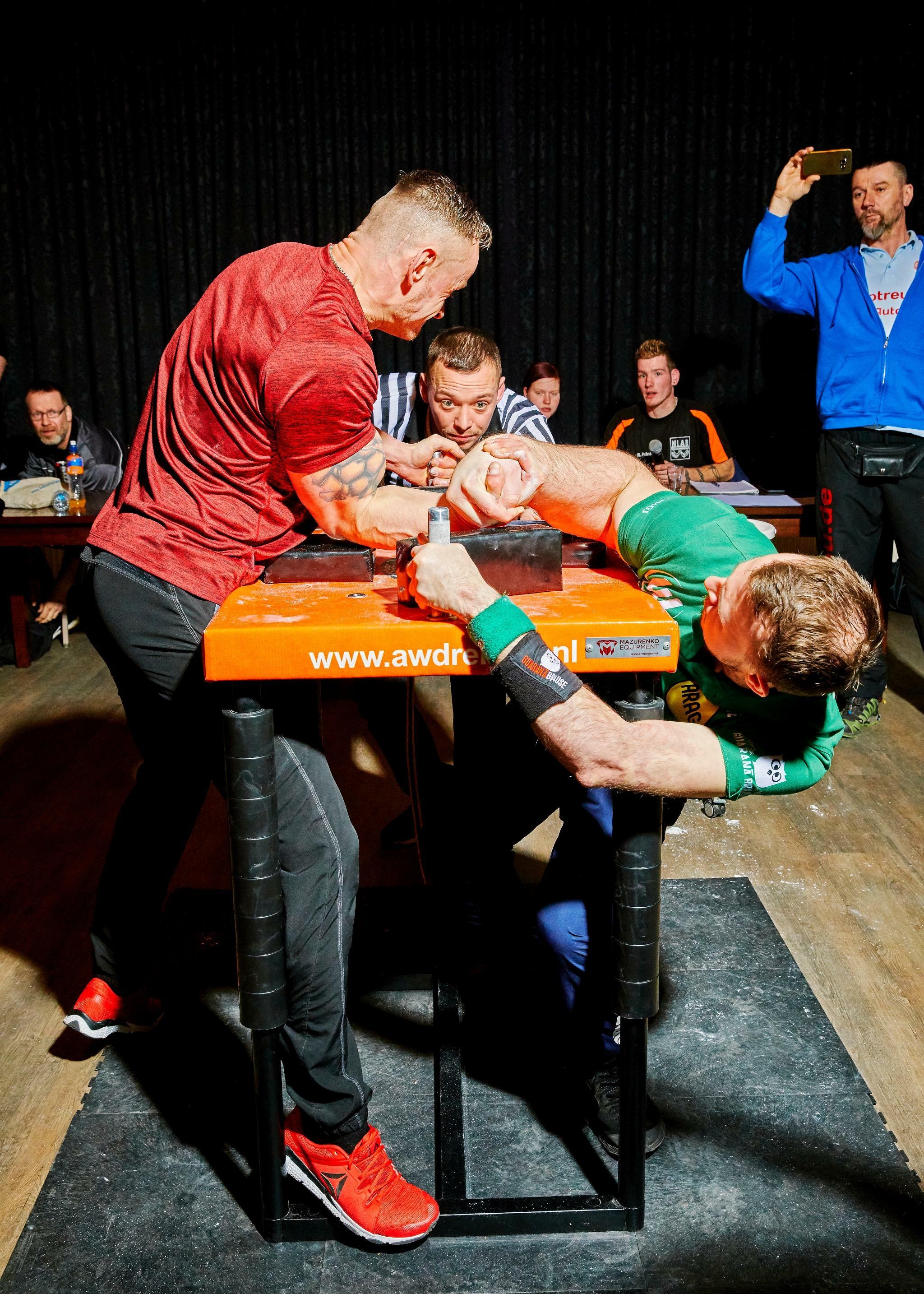 Arm Wrestling: Indoor sports competition, Man's wrestling tournament, Top roll technique, Wrist wrestling. 2050x2870 HD Background.