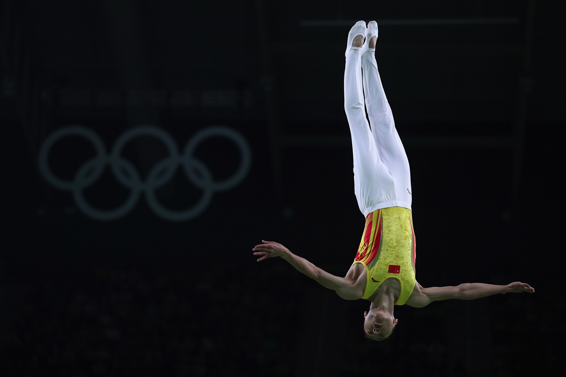 Trampoline gymnastics: A gymnast from China performs acrobatics in the air at the Summer Olympic Games. 2400x1600 HD Wallpaper.