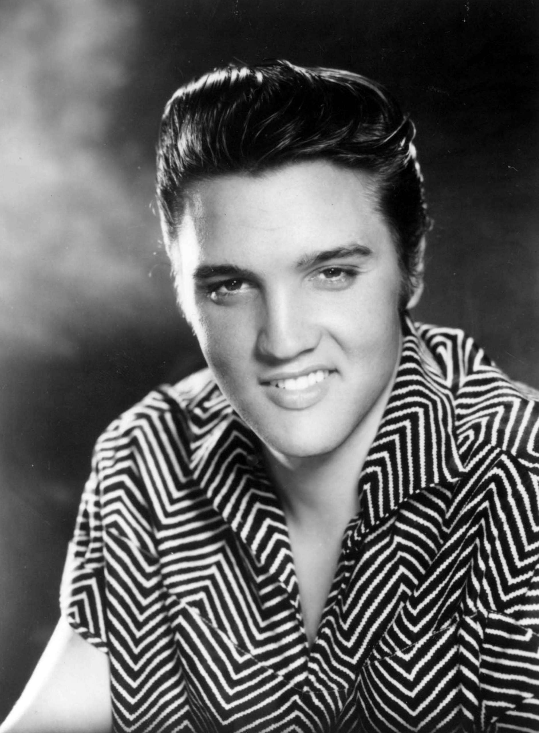 Elvis Presley: The performer who kicked off a musical revolution by modernizing traditional genres such as blues and country. 1890x2560 HD Background.