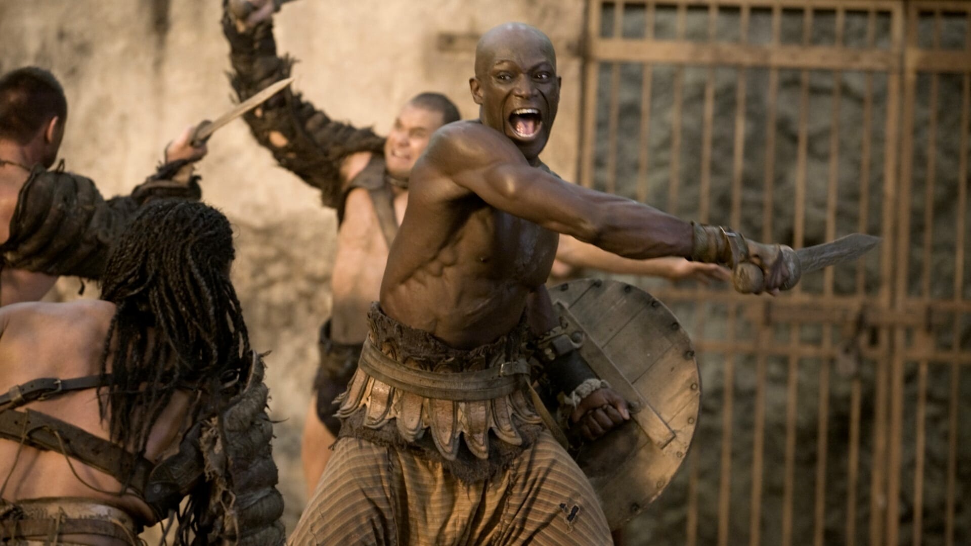 Spartacus: Gods of the Arena: Peter Mensah as Oenomaus, the gladiator trainer in Batiatus' Ludus. 1920x1080 Full HD Background.