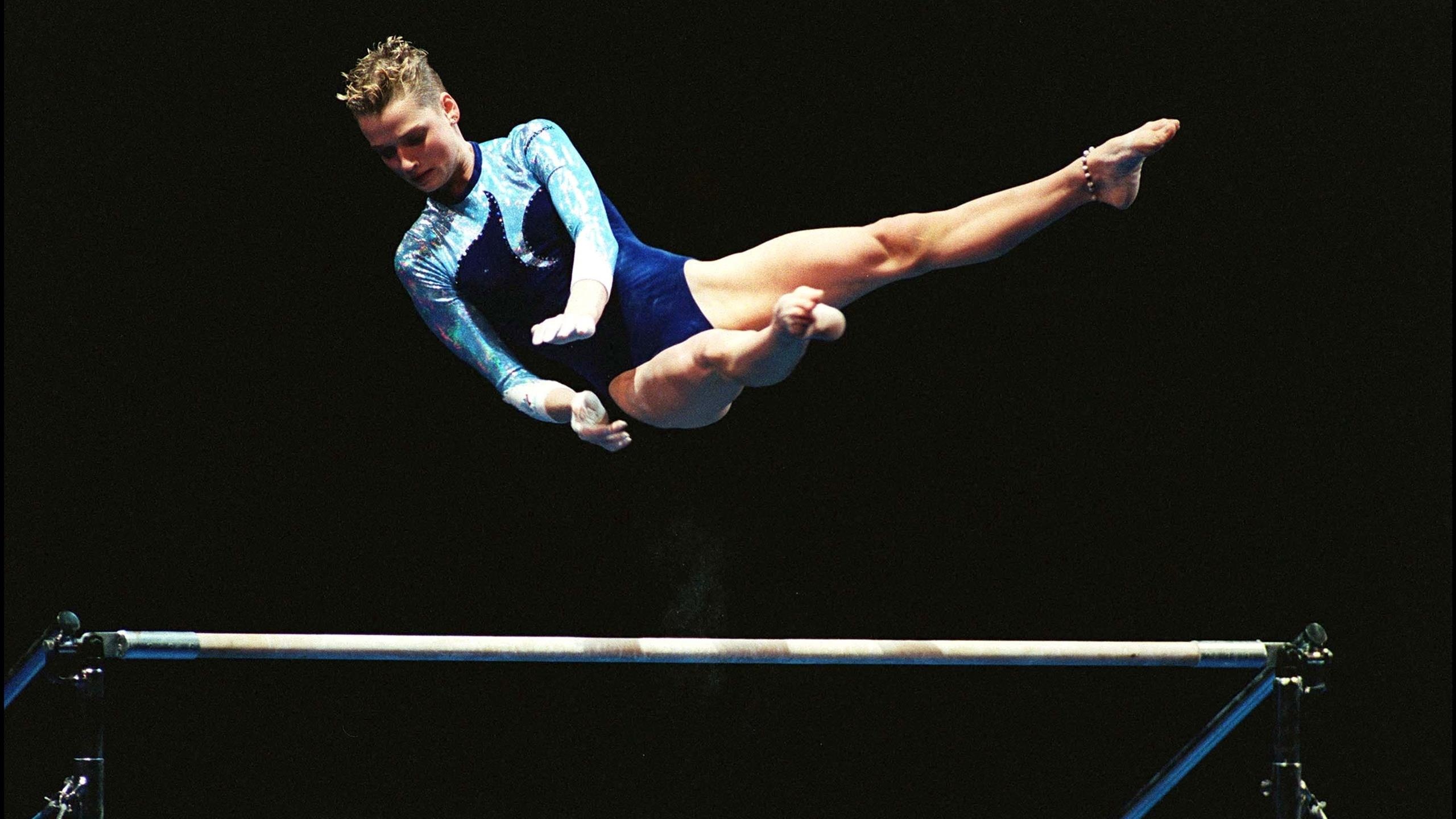 Uneven Bars: Svetlana Khorkina, The best gymnast of the 1990s, The vice-president of Russian Gymnastics Federation. 2560x1440 HD Background.