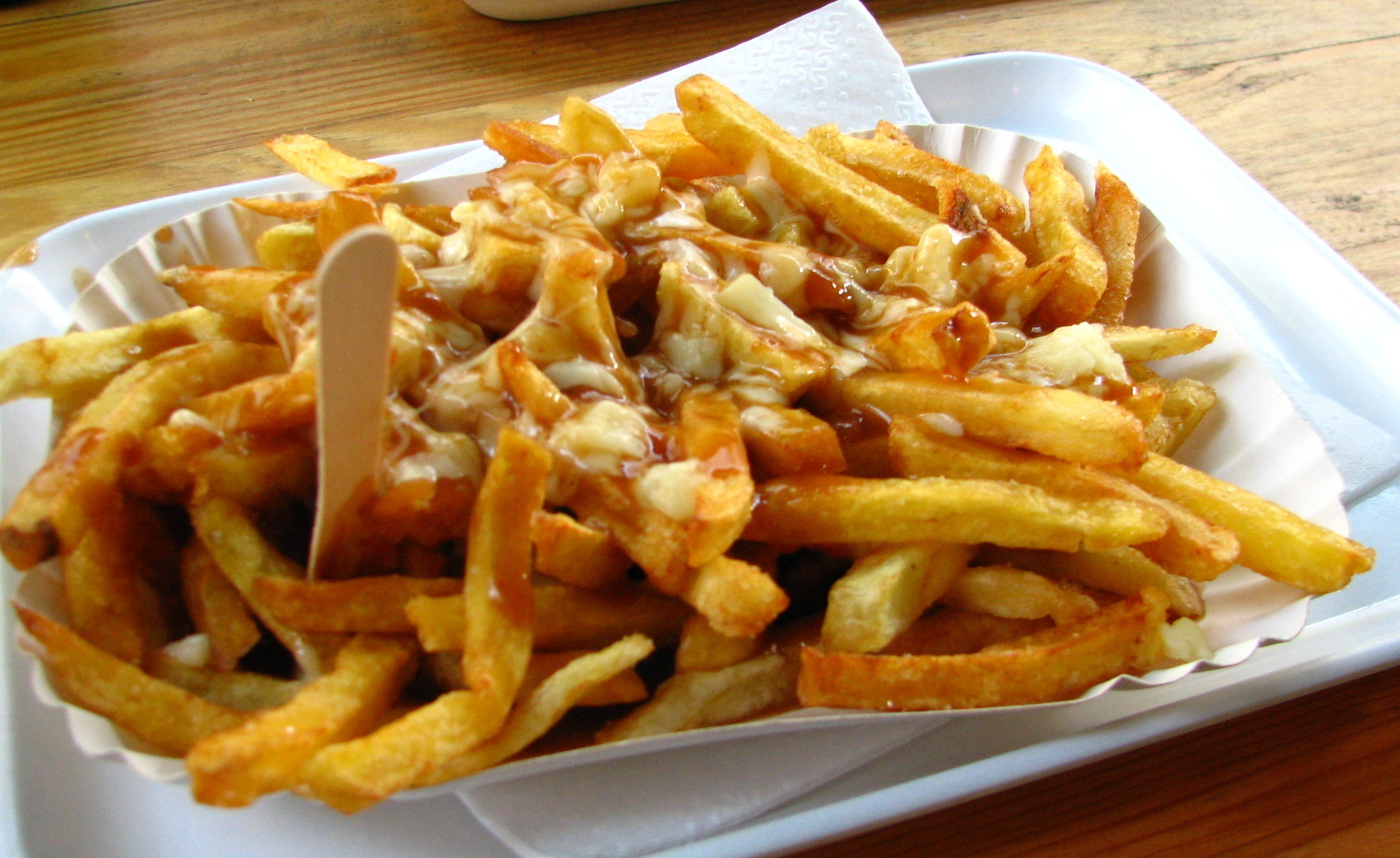 French Fries: Poutine, A Canadian dish of potatoes covered with cheese curds and gravy. 2330x1430 HD Background.