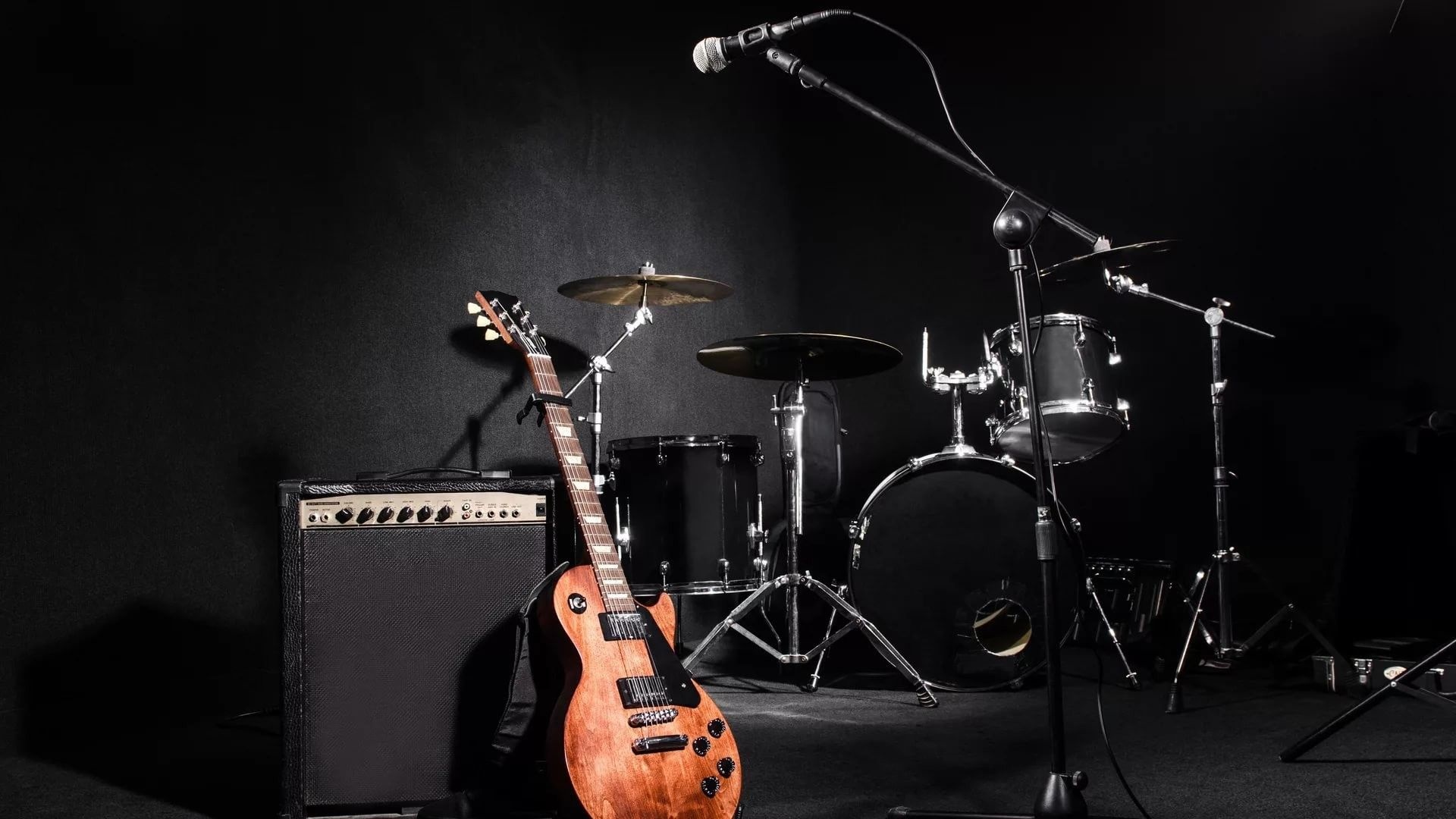 Musical Instruments: Rock band Instrument, The lead guitar plugged into an amp, A standard, four-piece drum set. 1920x1080 Full HD Background.