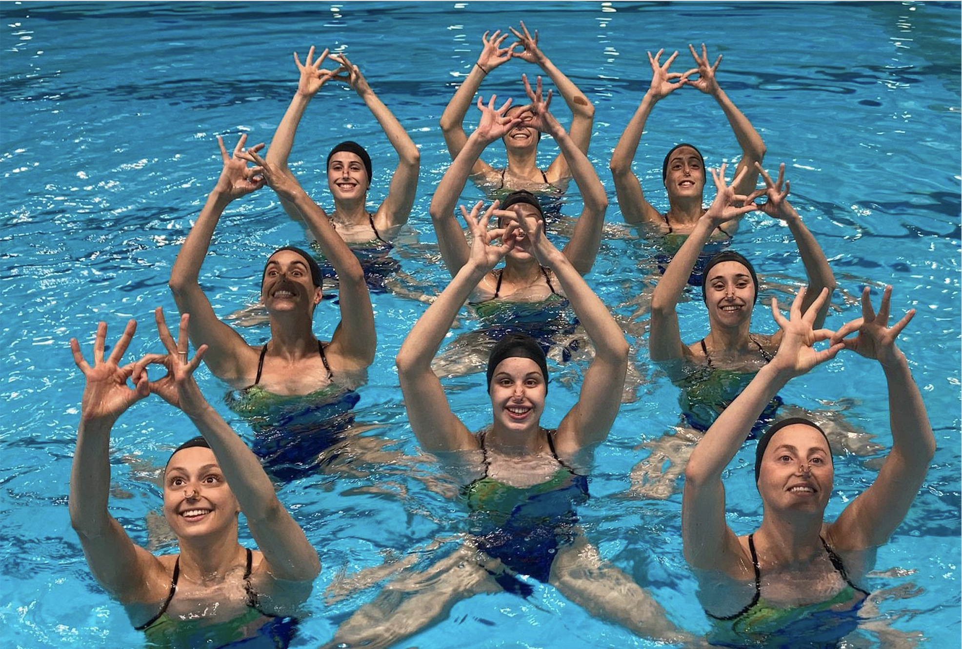 Synchronized Swimming: The Spanish artistic swimming national team performs a routine training. 1980x1340 HD Background.