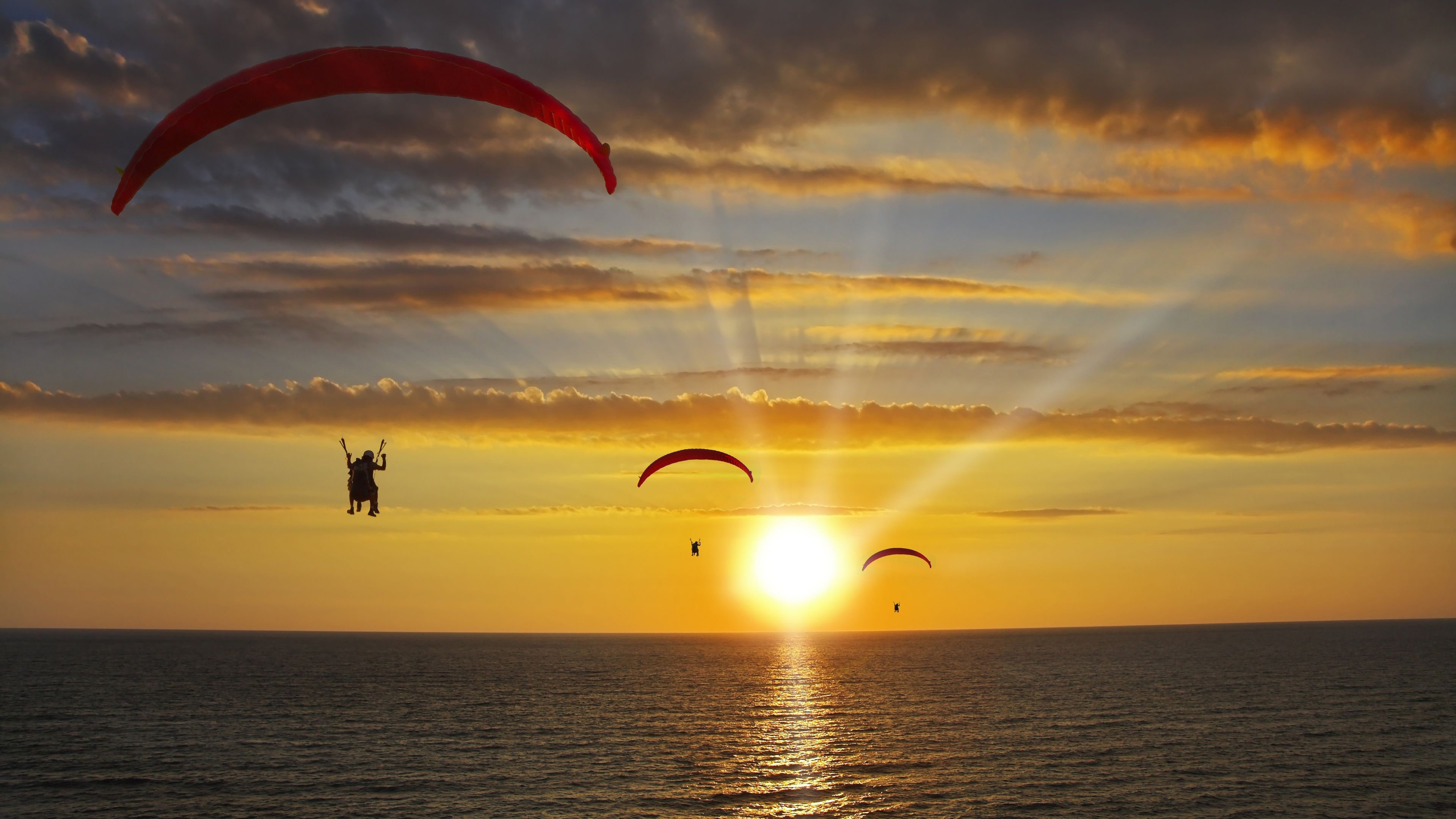 Paragliding: Operated Parachutes Above The Sea, Competitive adventure sport. 3840x2160 4K Background.