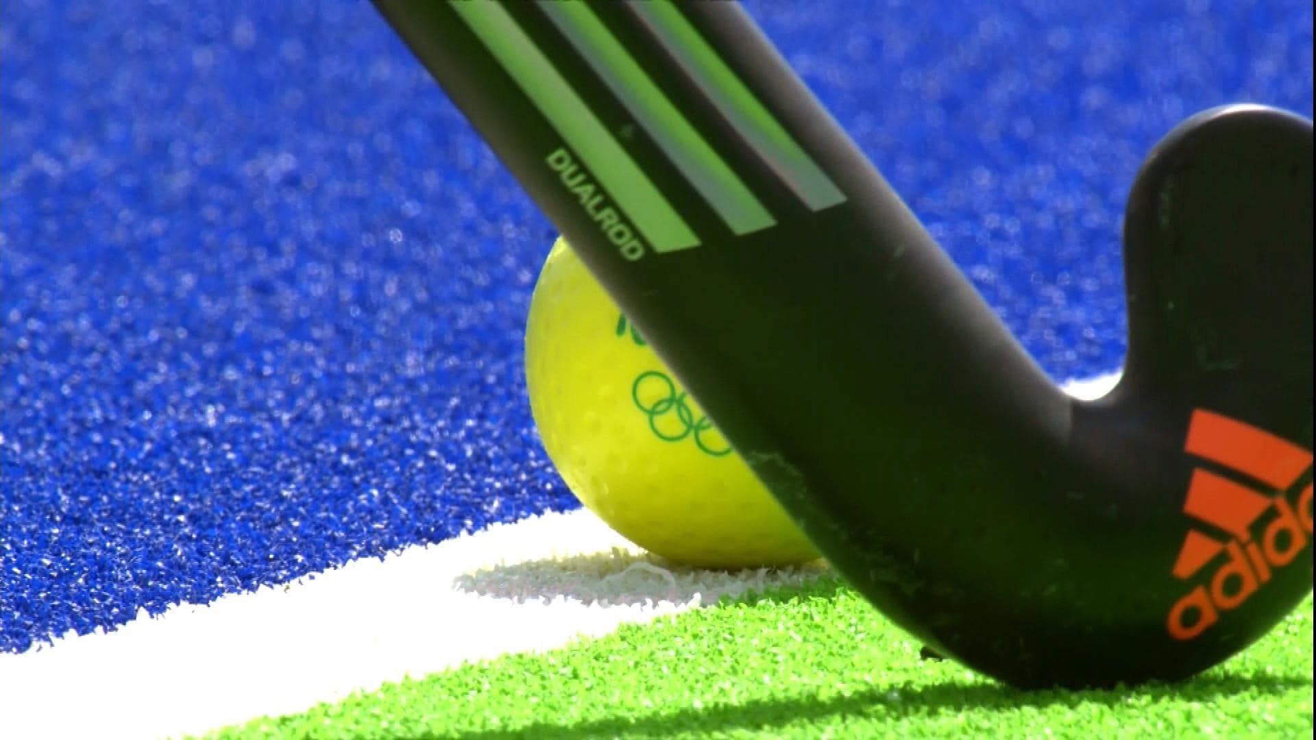 Field Hockey: A stick and an Olympic-style ball - equipment for a competitive ball game. 1920x1080 Full HD Background.