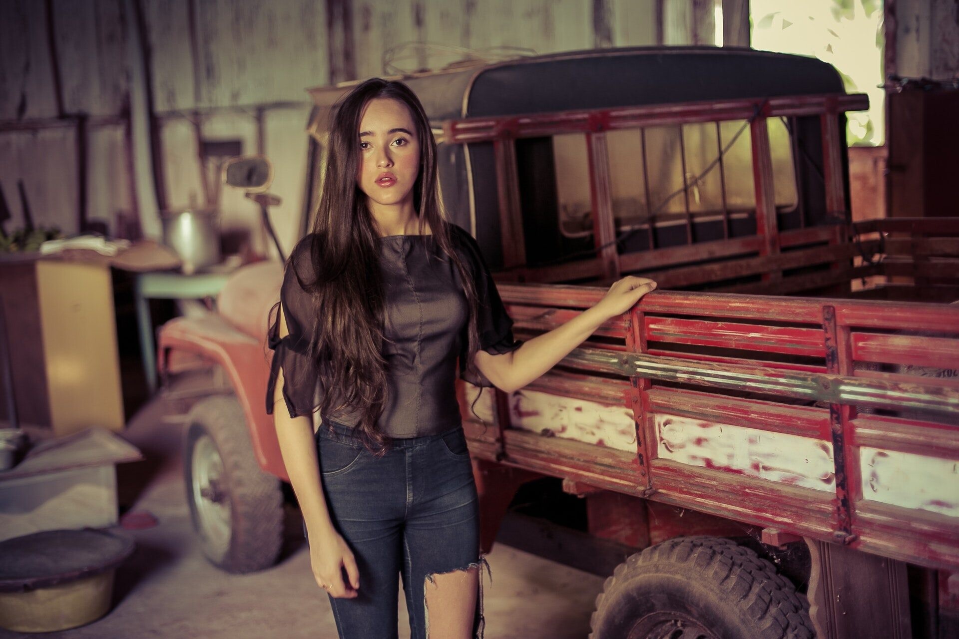 Girls and Trucks: An old red pickup, Vehicle shed, Automotive tire, Distressed jeans. 1920x1280 HD Background.