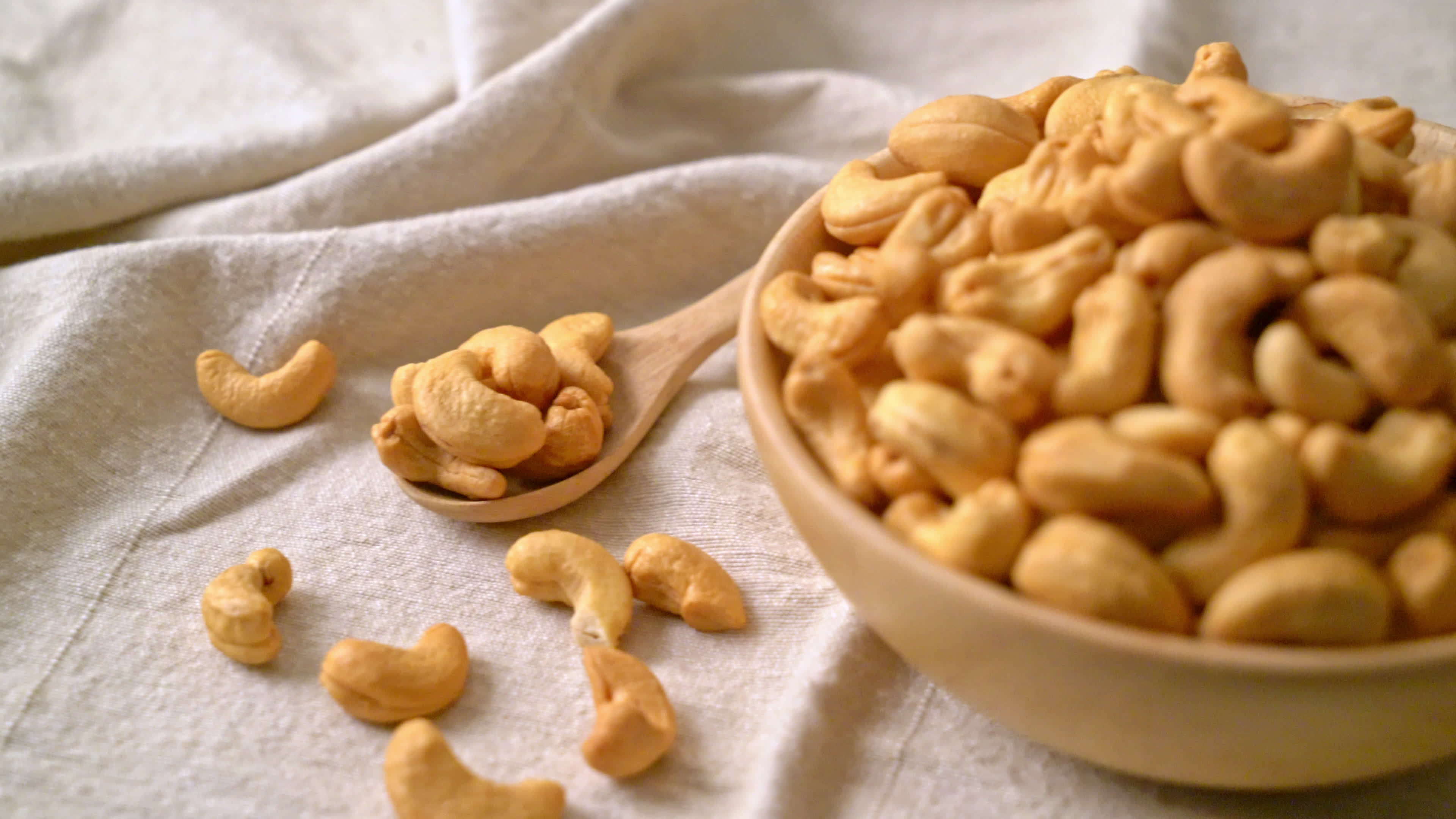 Cashew Nuts: A kidney-shaped seed sourced from the cashew tree, A snack nut. 3840x2160 4K Background.