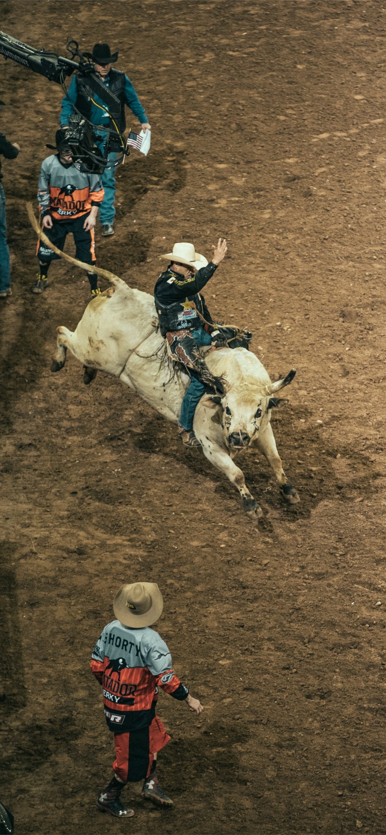 Bullriding: A sport where the rider must hang on with one hand for 8 seconds, A rodeo challenge. 1290x2780 HD Background.