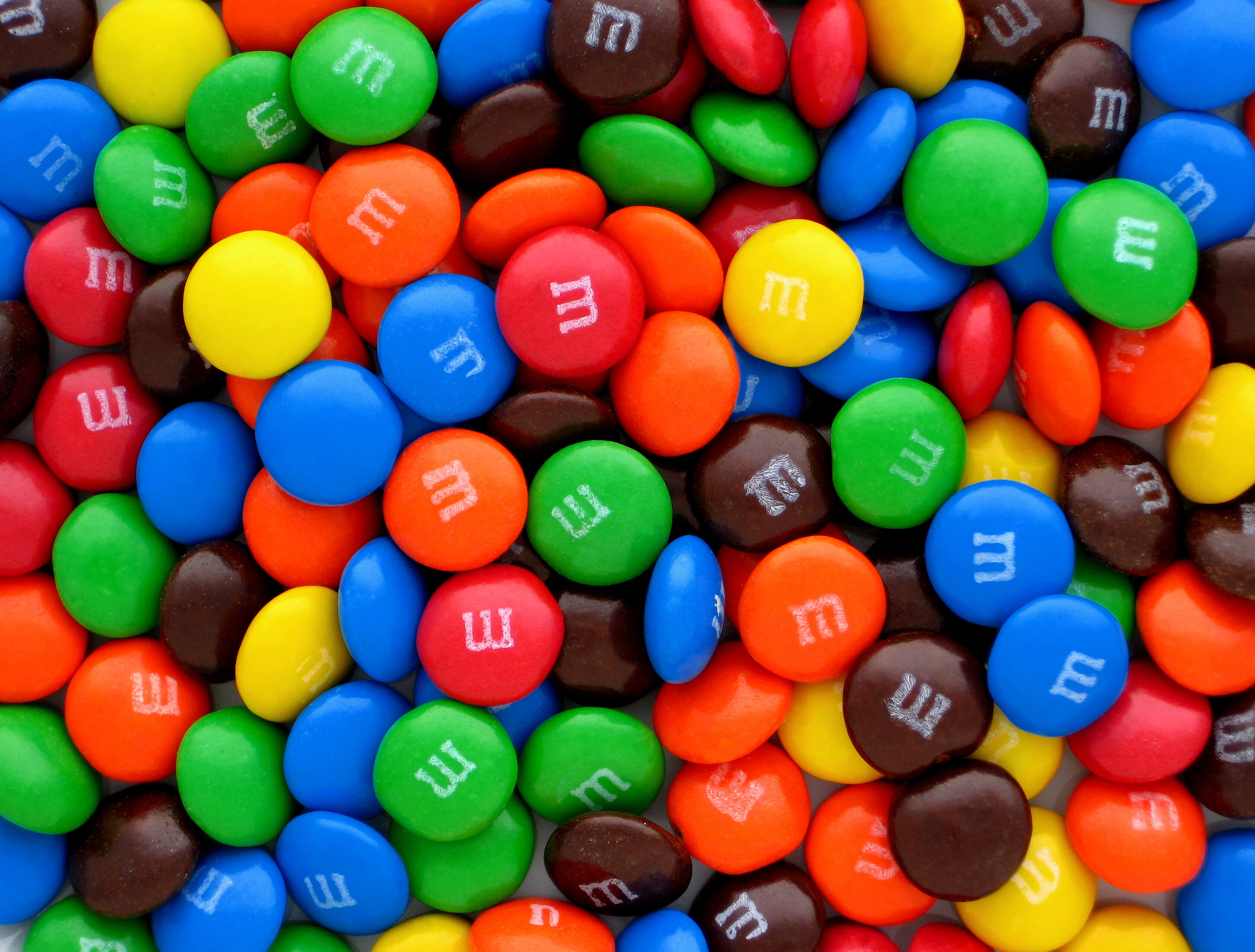 M&M’s: Consists of a candy shell surrounding a filling which varies depending on the variety. 2900x2200 HD Background.
