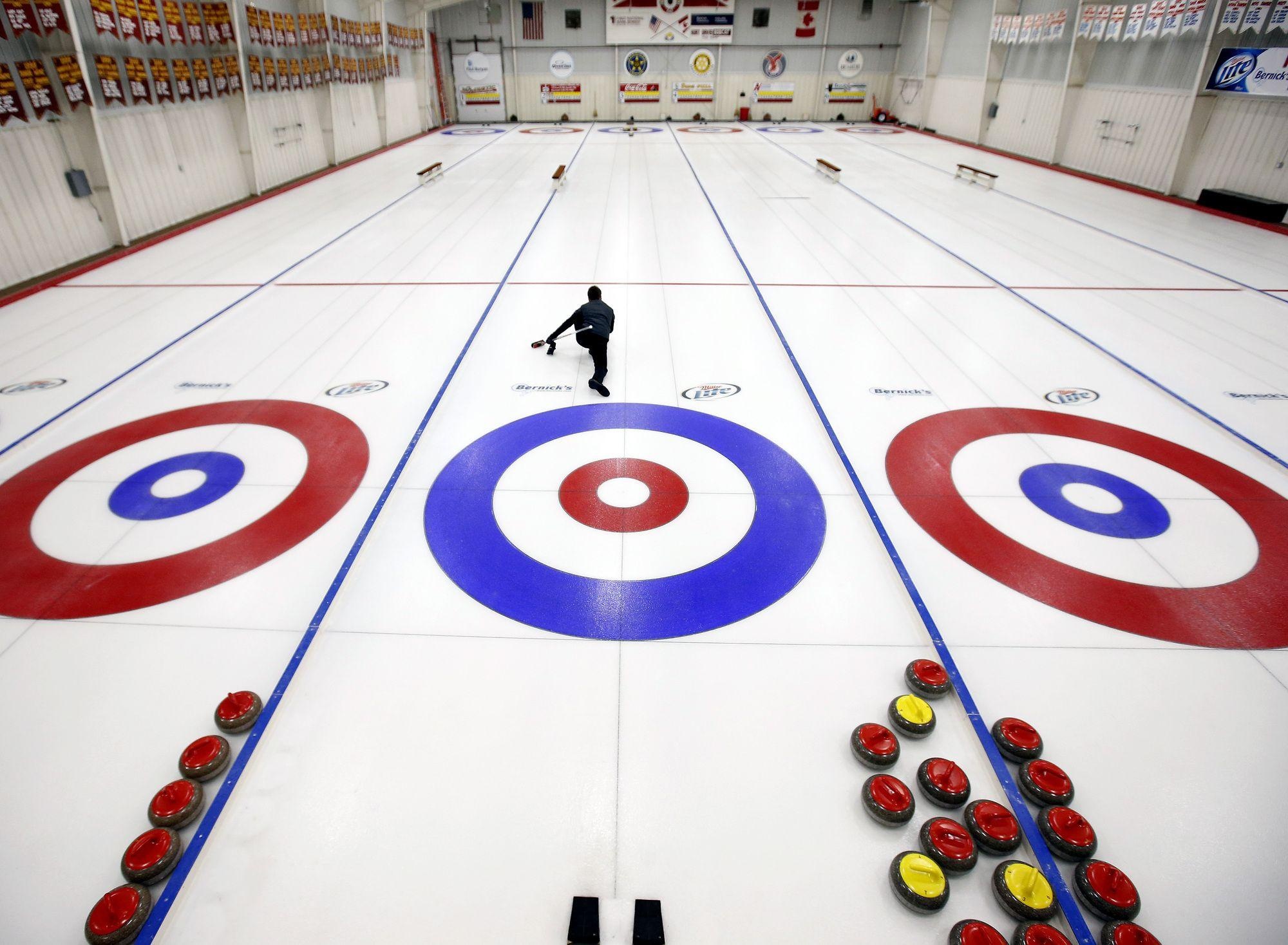 Curling: A sport in which players slide stones on a sheet of ice toward a target area. 2000x1470 HD Background.