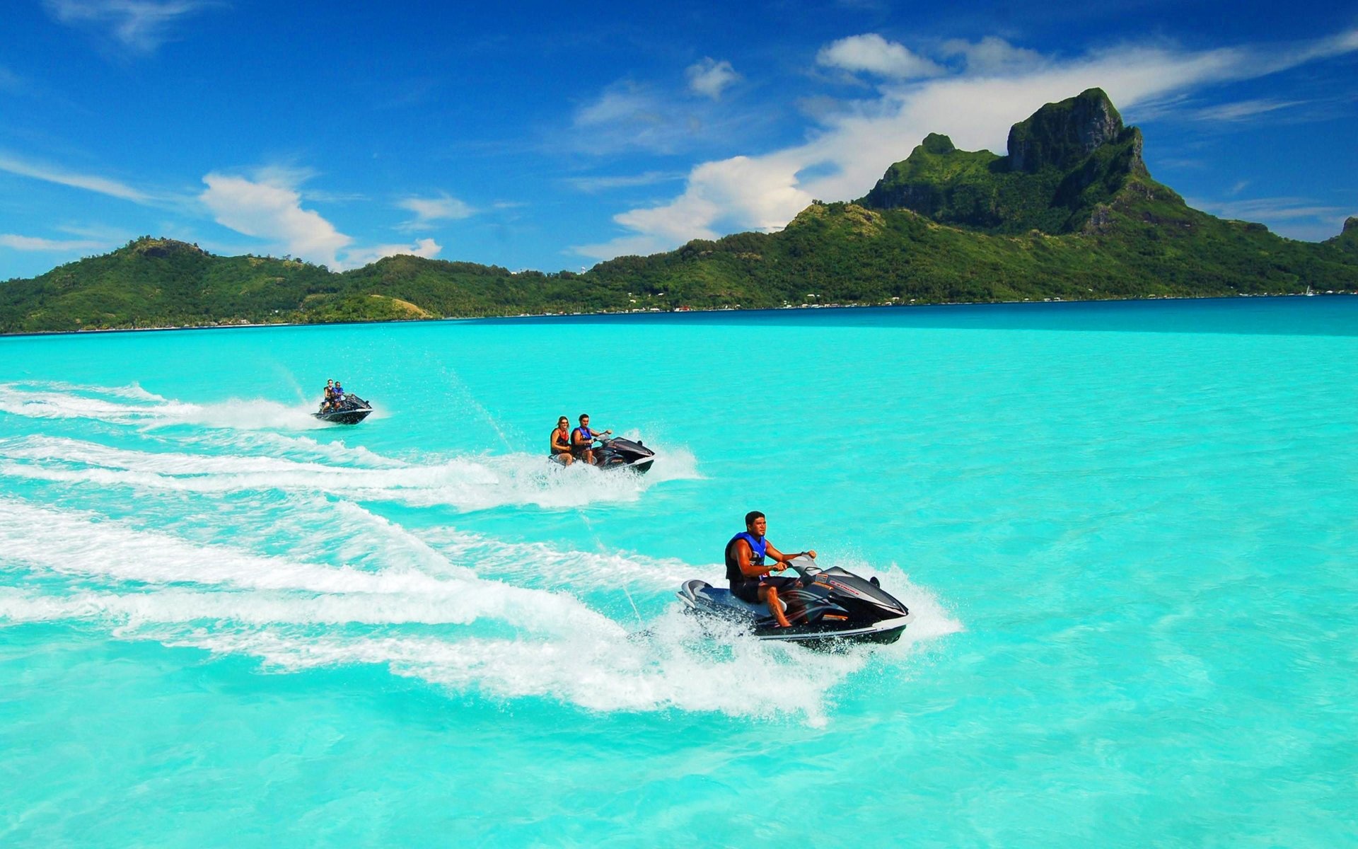 Bora Bora: A volcano set over one of the most beautiful lagoons in the world, Jet-skiing. 1920x1200 HD Background.