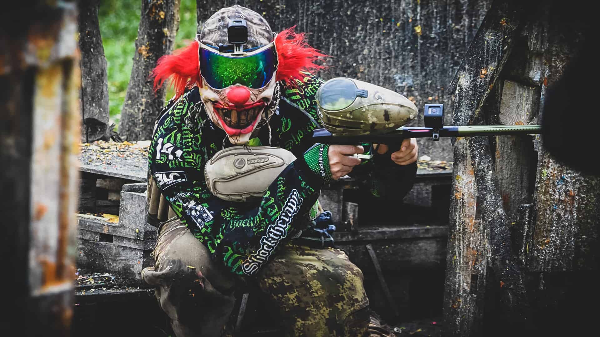 Paintball: A player wearing a clown-style shield mask, Woodsball shooting event. 1920x1080 Full HD Background.