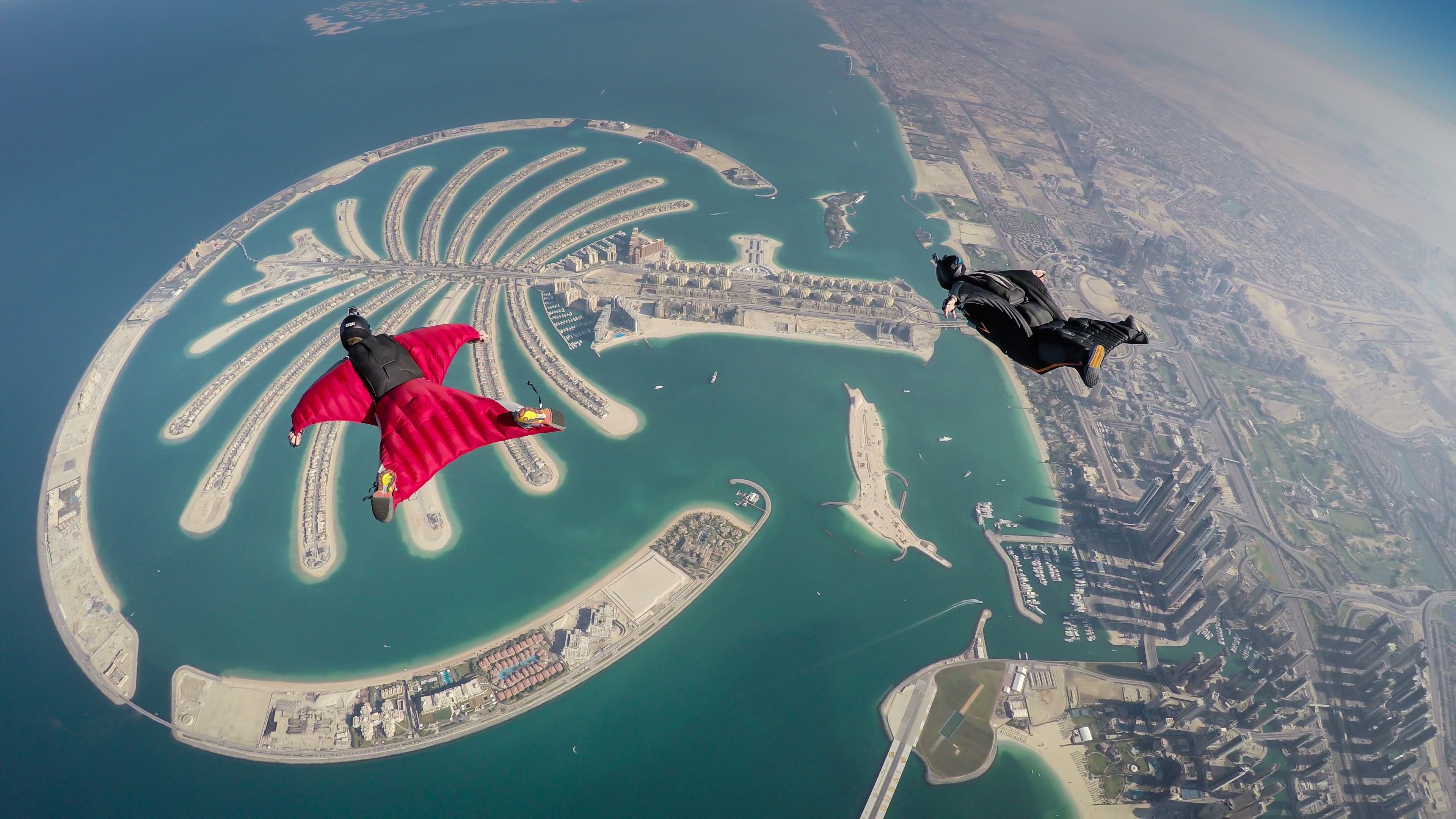 Wingsuit Flying: The Palm Jumeirah archipelago wingsuiting, Air sport in Dubai. 3840x2160 4K Wallpaper.