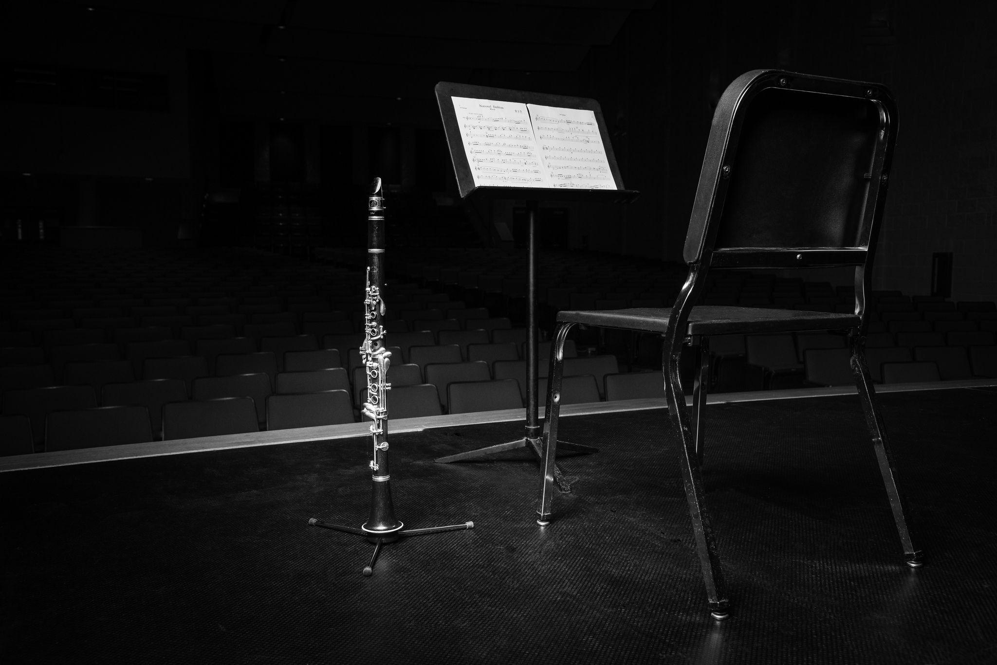 Clarinet: Orchestra chair, Music stand, Stage performance, Monochrome, Musical instrument on a stand. 2050x1370 HD Wallpaper.