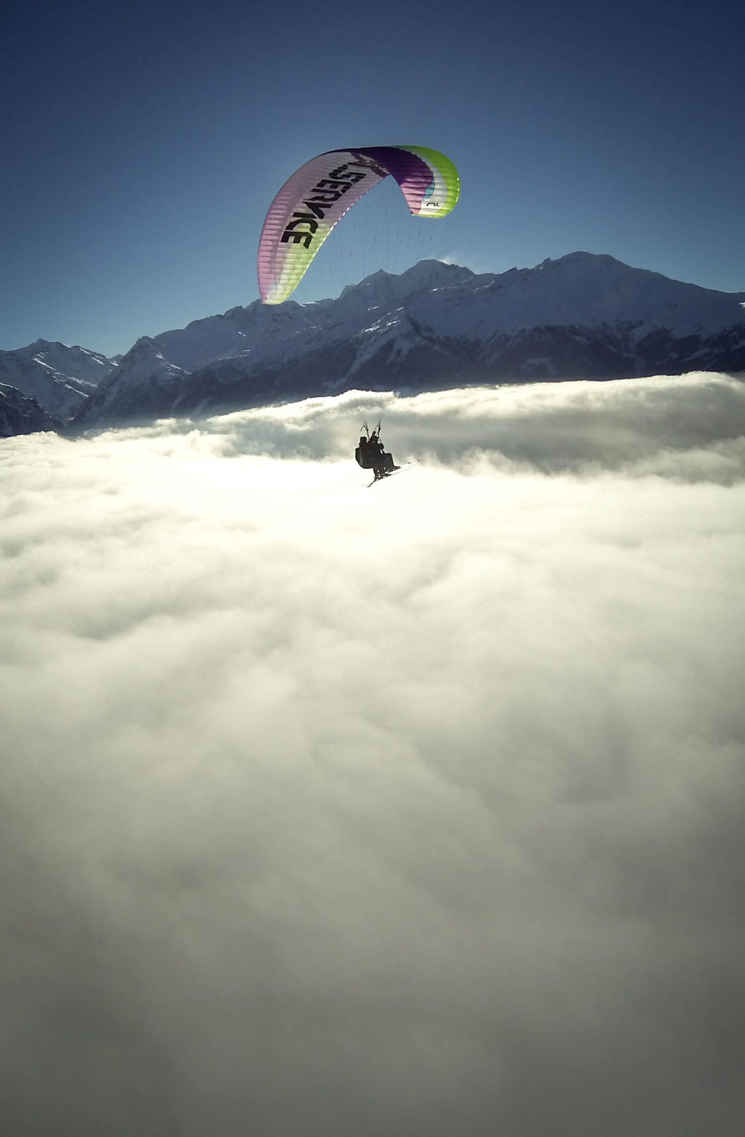 Paragliding: Operated parachute flying over Verbier, South-western Switzerland, Air sports. 1480x2250 HD Background.