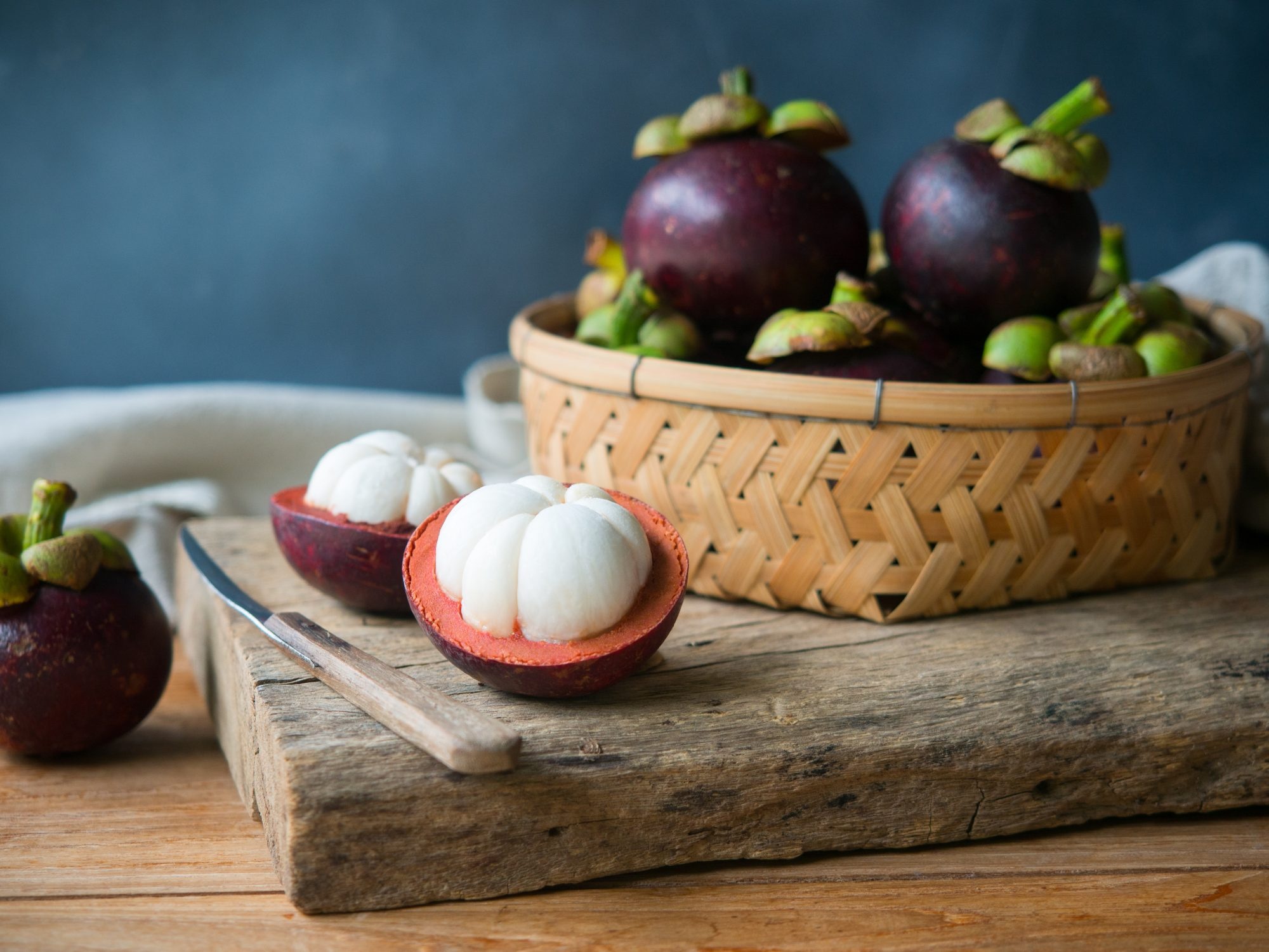 Mangosteen: Flesh consists of 4 to 8 juicy, triangular segments that are white-colored. 2000x1500 HD Background.