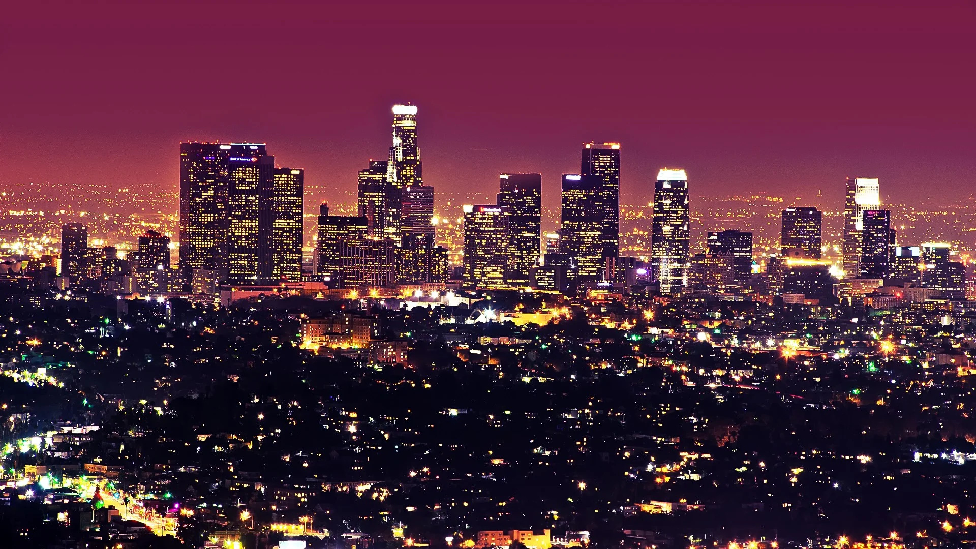 Los Angeles: Primarily a desert basin, the area is surrounded by the San Gabriel Mountain range and divided by the Santa Monica Mountains, Nightscape. 1920x1080 Full HD Background.