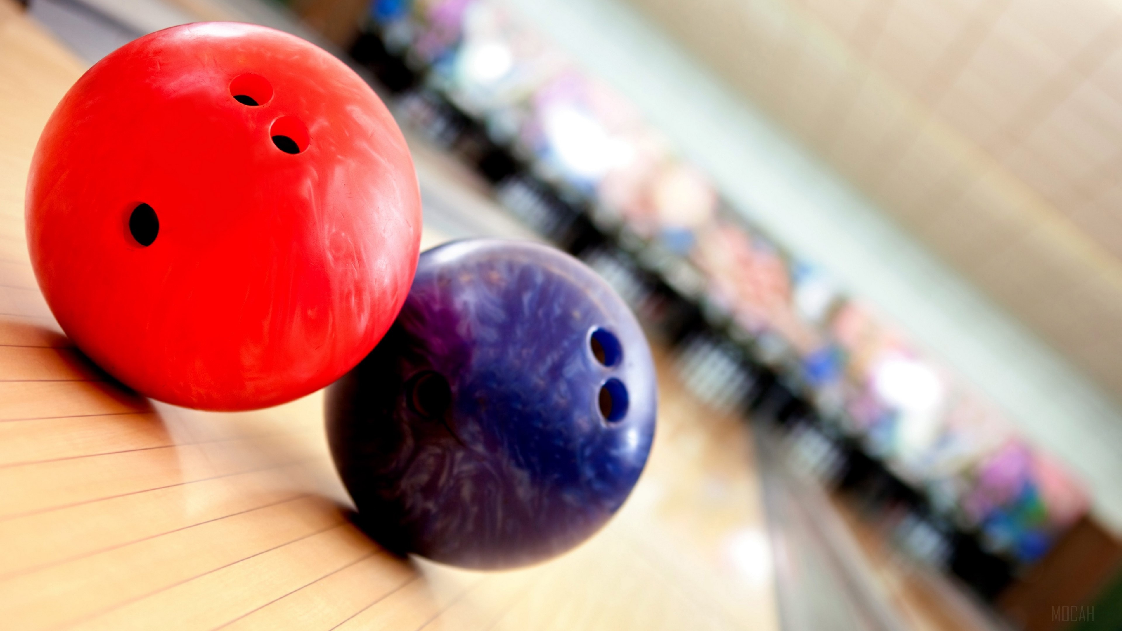 Bowling: A game in which a heavy ball is rolled at wooden pins set up at the opposite end. 3840x2160 4K Background.