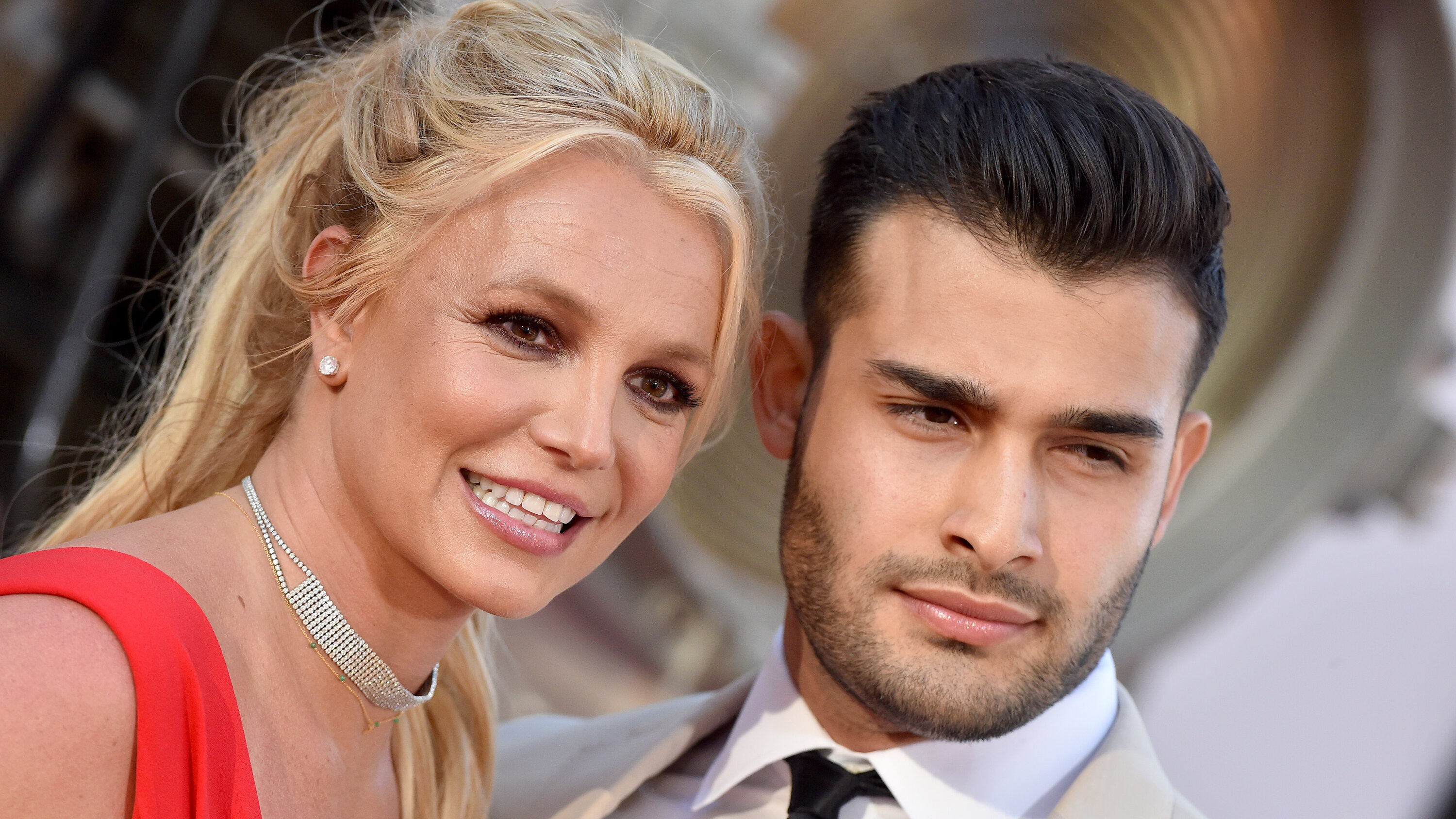 Sam Asghar and Britney Spears: Works as a model, personal trainer, and actor, An American pop singer. 3000x1690 HD Background.