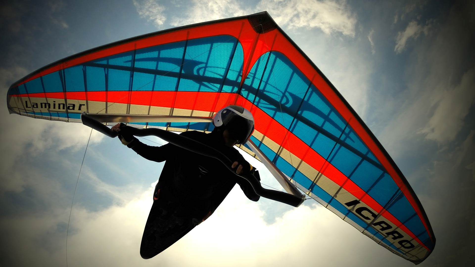 Gliding: Icaro Laminar foot-launched hang glider with a pilot in the pod. 1920x1080 Full HD Wallpaper.