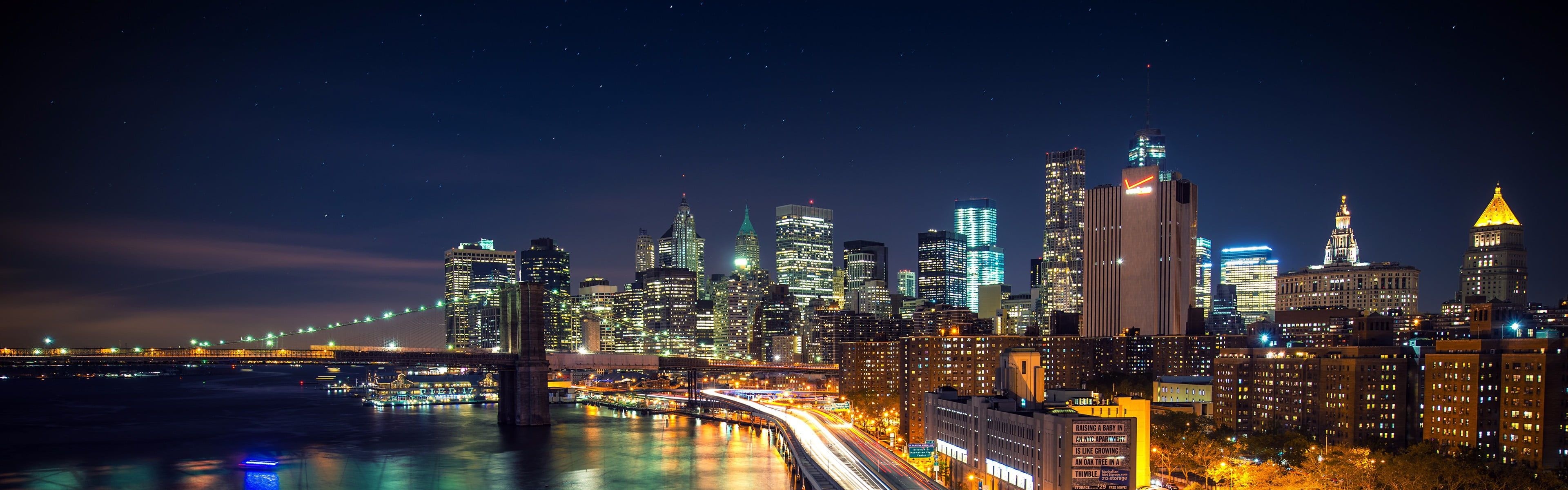 Cityscape: Brooklyn Bridge at night, Amazing city lights, Empire State Building, Manhattan, New York. 3840x1200 Dual Screen Wallpaper.