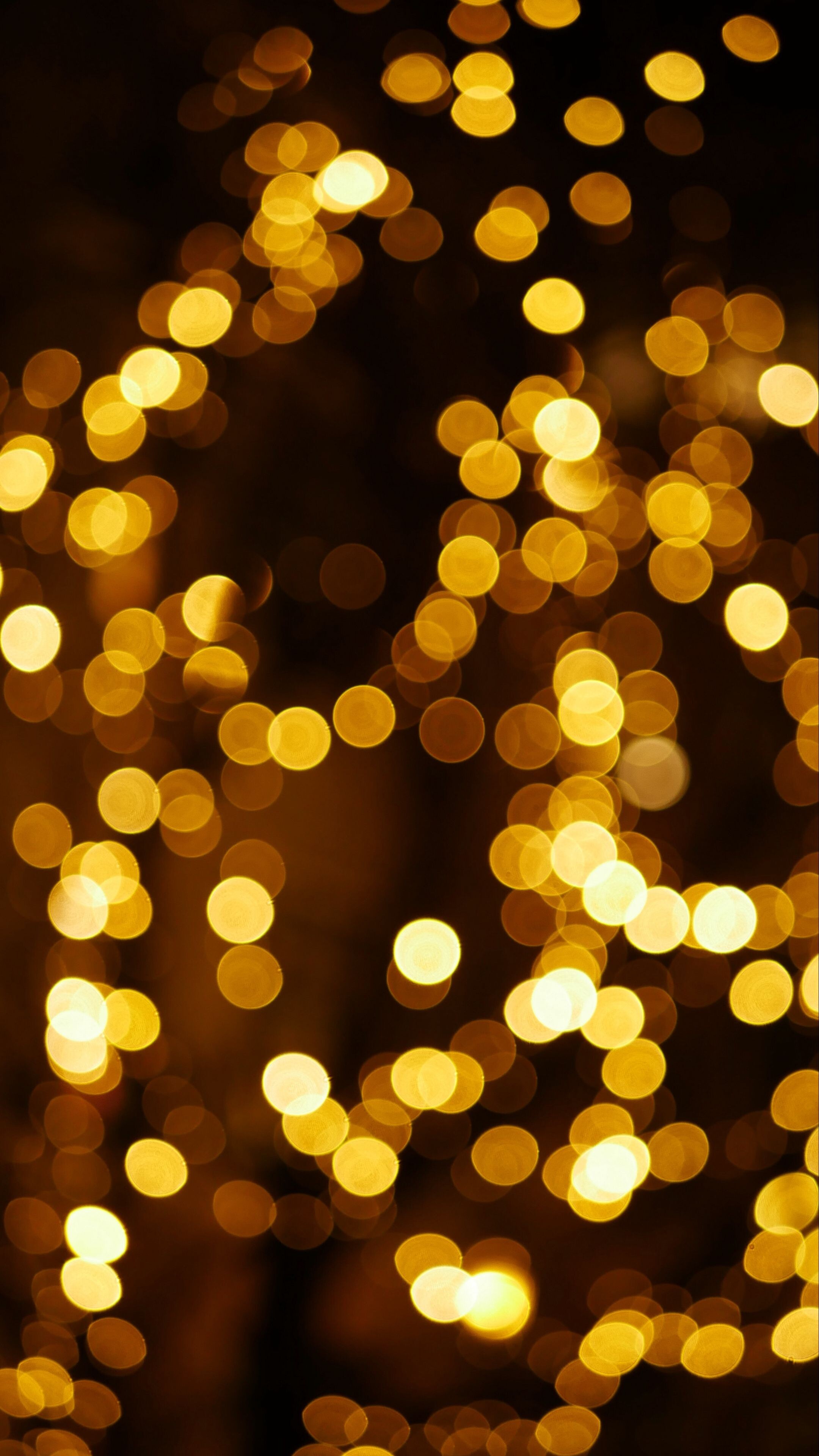 Gold Lights: Light shining through the blurred frosted window glass, Bokeh effect, Sparkling golden bubbles. 2160x3840 4K Background.